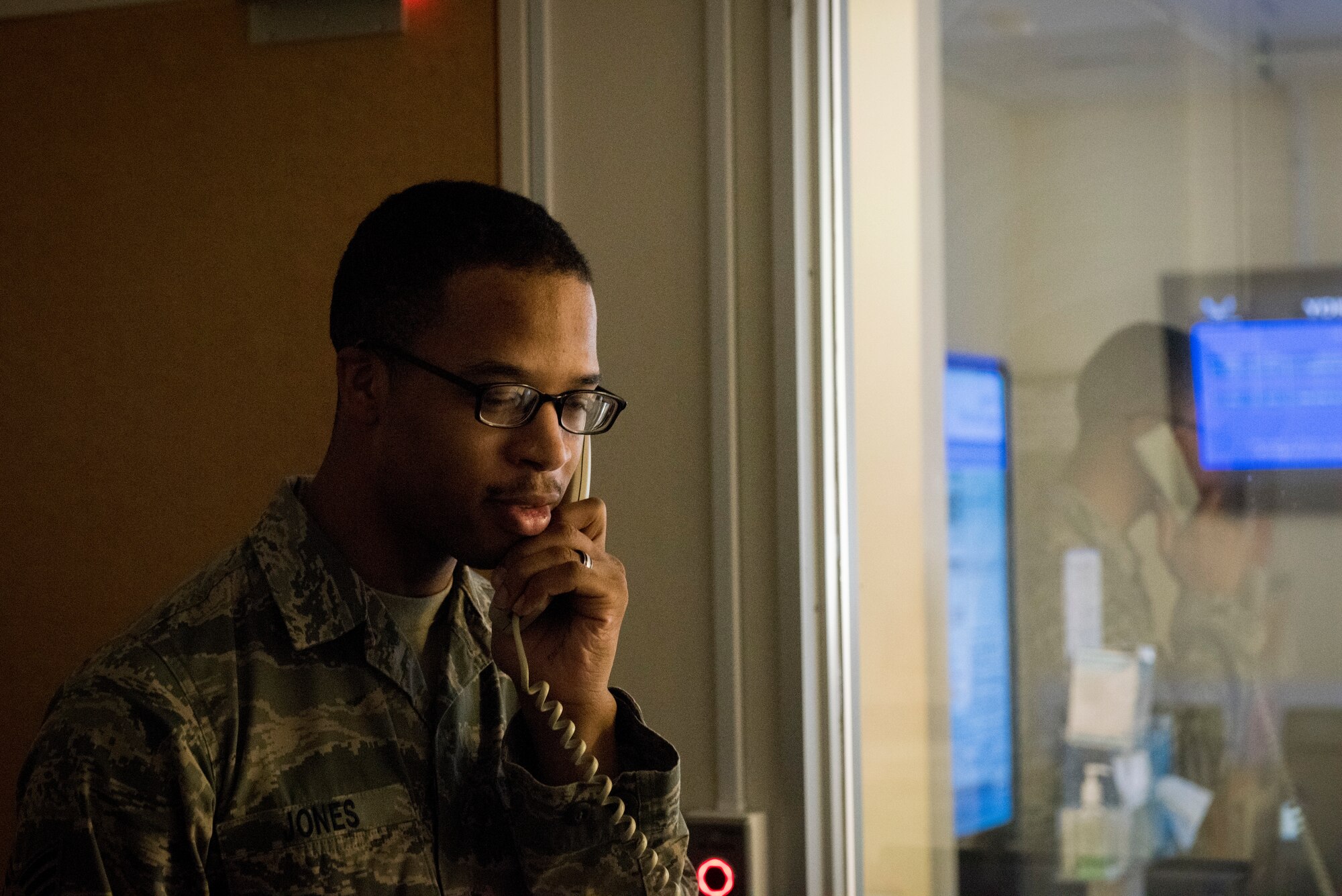 Senior Airman William Jones, 374th Medical Group lab technician, makes a call to the 459th Airlift Squadron requesting a patient transfer by helicopter to U.S. Fleet Activities Yokosuka, March 30, 2018, at Yokota Air Base, Japan.