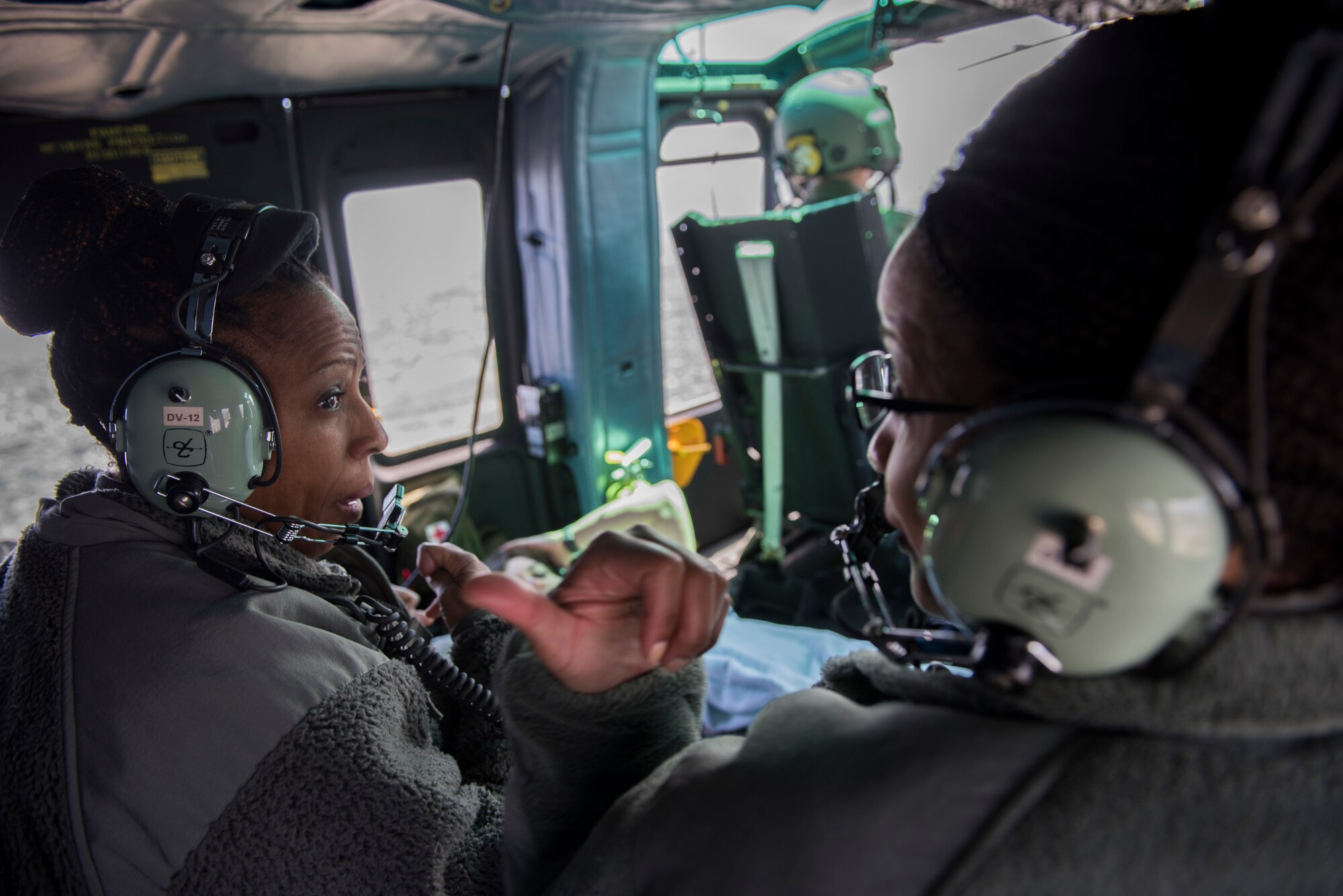 Members of the 374th Medical Group discuss procedures during patient transport training in a UH-N1 Iroquois, March 30, 2018, near U.S. Fleet Activities Yokosuka, Japan.