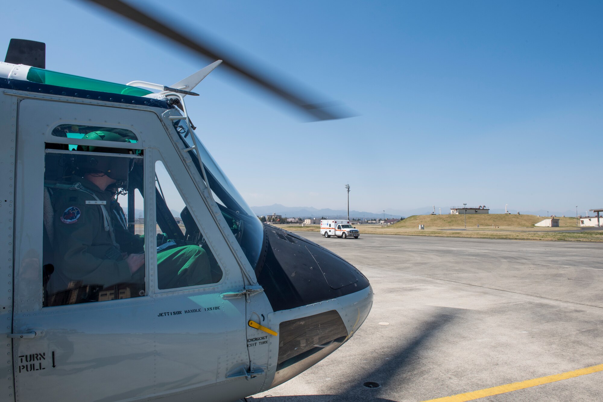 Pilots with the 459th Airlift Squadron watch an ambulance to approach during patient transport training, March 30, 2018, at Yokota Air Base, Japan.