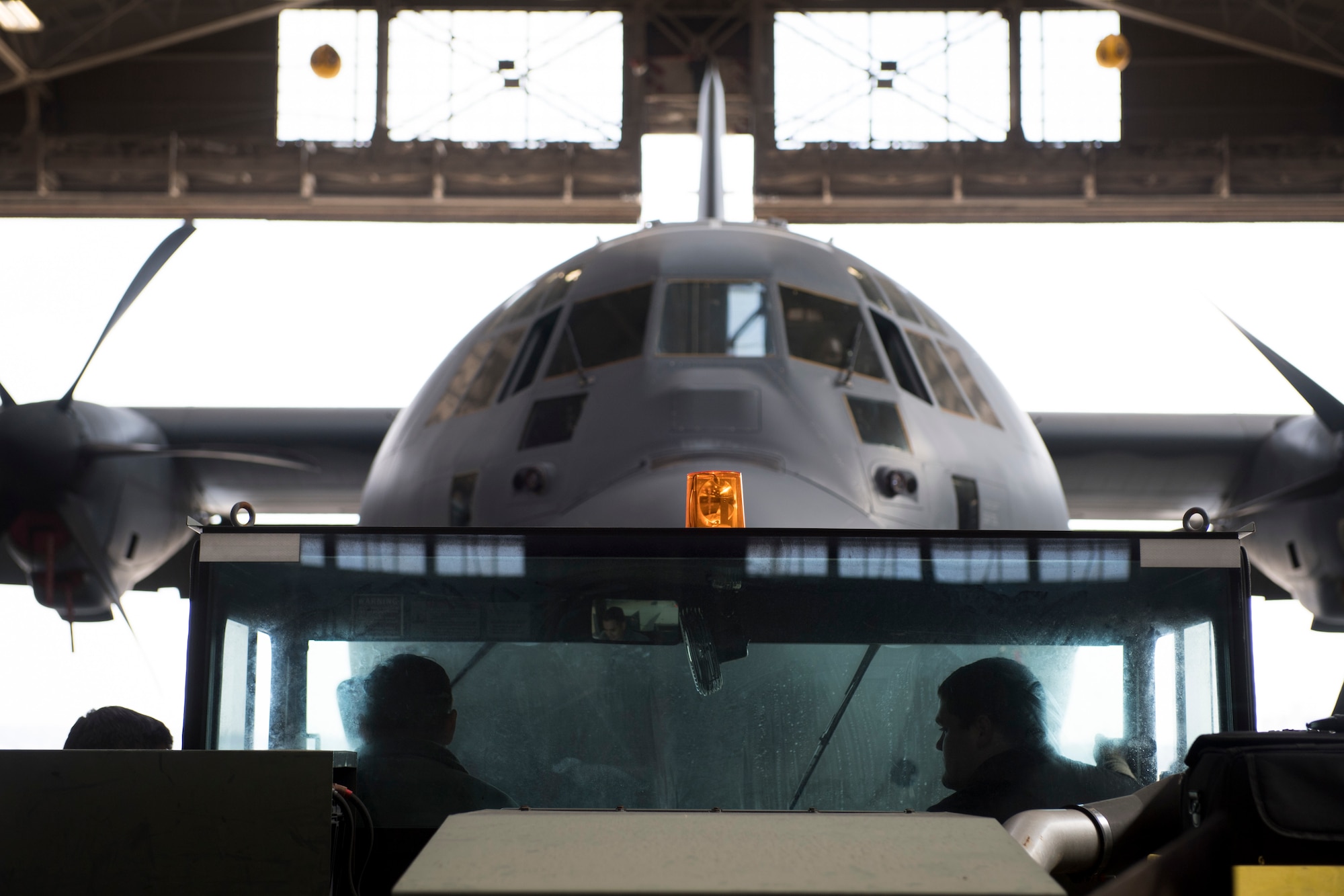 Airman with the 374th Maintenance Squadron prepare to tow a C-130J Super Hercules out of a hangar, Feb. 27, 2018, at Yokota Air Base, Japan.