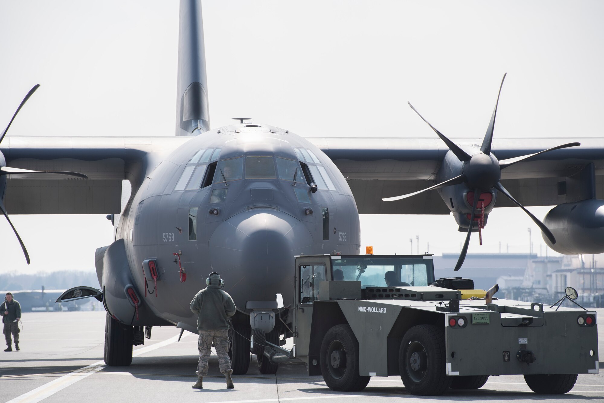 Airman with the 374th Maintenance Squadron tow a C-130J Super Hercules across the flightline, Feb. 27, 2018, at Yokota Air Base, Japan.