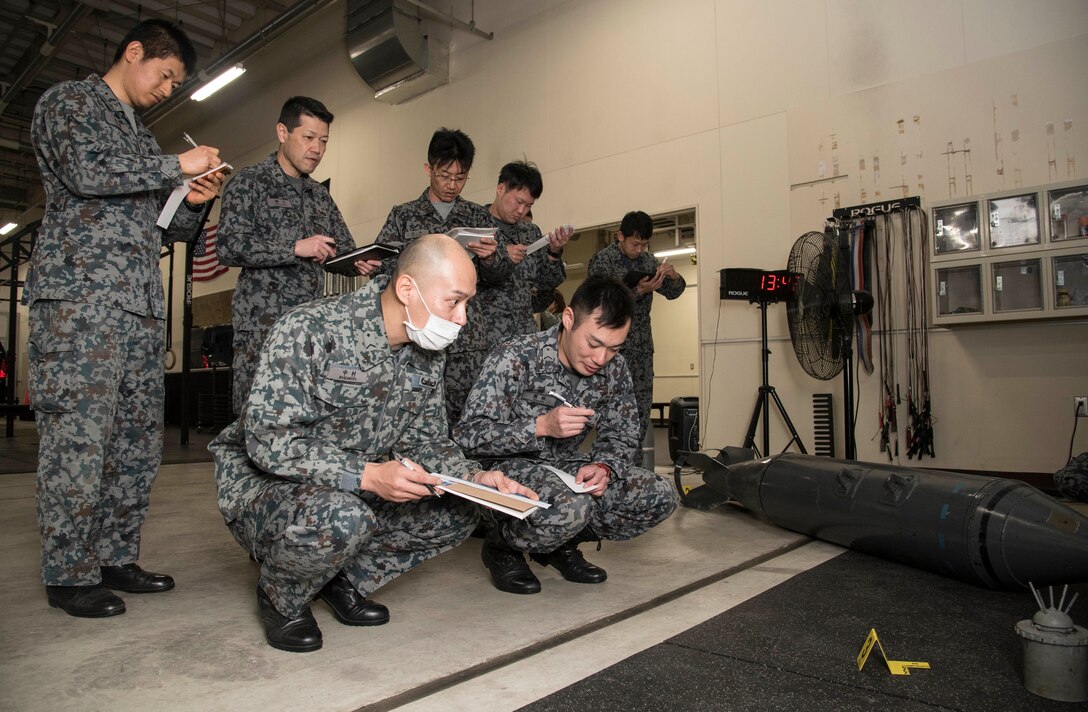 Japan Air Self-Defense Force 3rd Air Wing weapons maintenance technicians and Tohoku Sub
Base, Tohoku, Japan, explosive ordnance disposal instructors classify an inert unexploded
ordnance as a part of their EOD training school requirements at Misawa Air Base, Japan, March
29, 2018. In order to better protect Japan and its allies, the 35th Civil Engineer Squadron EOD
flight trained instructors from JASDF Tohoku EOD School the basics of identifying and
responding to UXOs. Despite the language barrier, all members took away knowledge to bring
back to their units. (U.S. Air Force photo by Senior Airman Sadie Colbert)