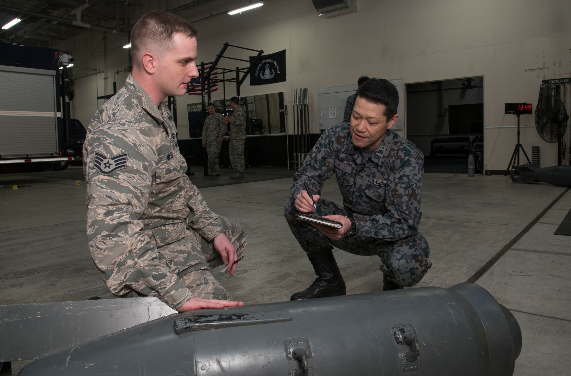 U.S. Air Force Staff Sgt. Kyle Miller, left, the 35th Civil Engineer Squadron explosive ordnance
disposal NCO in charge, explains the makeup of a Russian bomb to Japan Air Self-Defense
Force Master Sgt. Tomomune Segawa, a Tohoku EOD School instructor, at Misawa Air Base,
Japan, March 29, 2018. Tohoku instructors attended the course in order to better their ordnance
disposal skills for future bilateral missions. Once complete, the instructors took their newly
gained knowledge and delivered it to their units. (U.S. Air Force photo by Senior Airman Sadie
Colbert)