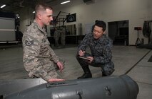 U.S. Air Force Staff Sgt. Kyle Miller, left, the 35th Civil Engineer Squadron explosive ordnance
disposal NCO in charge, explains the makeup of a Russian bomb to Japan Air Self-Defense
Force Master Sgt. Tomomune Segawa, a Tohoku EOD School instructor, at Misawa Air Base,
Japan, March 29, 2018. Tohoku instructors attended the course in order to better their ordnance
disposal skills for future bilateral missions. Once complete, the instructors took their newly
gained knowledge and delivered it to their units. (U.S. Air Force photo by Senior Airman Sadie
Colbert)