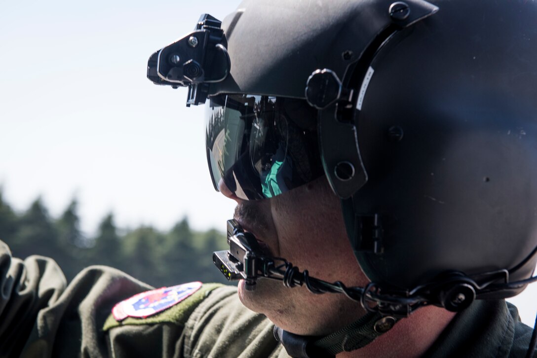 Technical Sgt. Robert Smeaton, 459th Airlift Squadron UH-N1 Iroquois flight engineer, secures patient stretcher to a helicopter during patient transfer training, March 30, 2018, at Yokota Air Base, Japan.