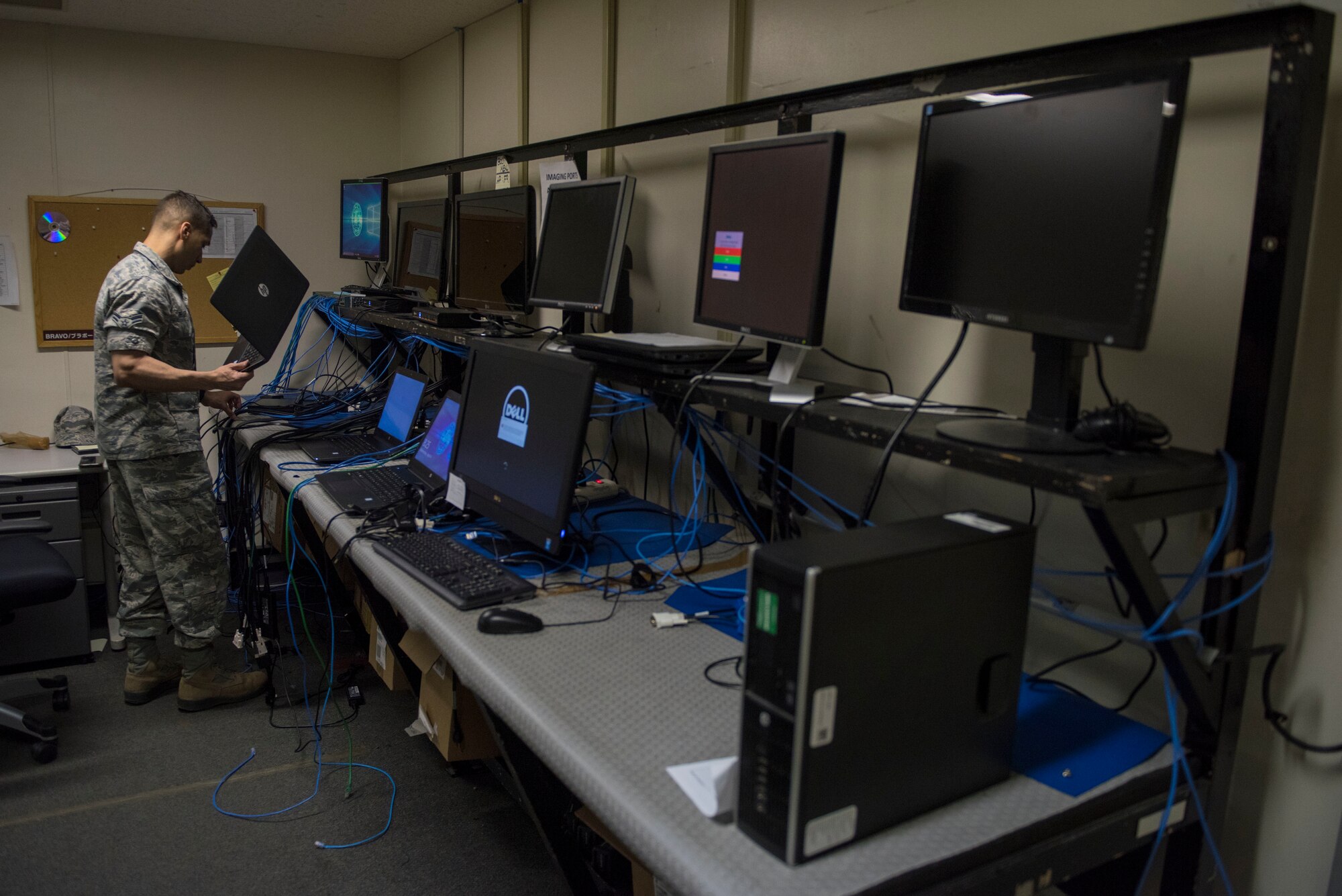 Airman 1st Class Andrews De Leon, 374th Communications Squadron Operations Flight client systems technician apprentice, prepares to image a laptop at Yokota Air Base, Japan, April 4, 2018.