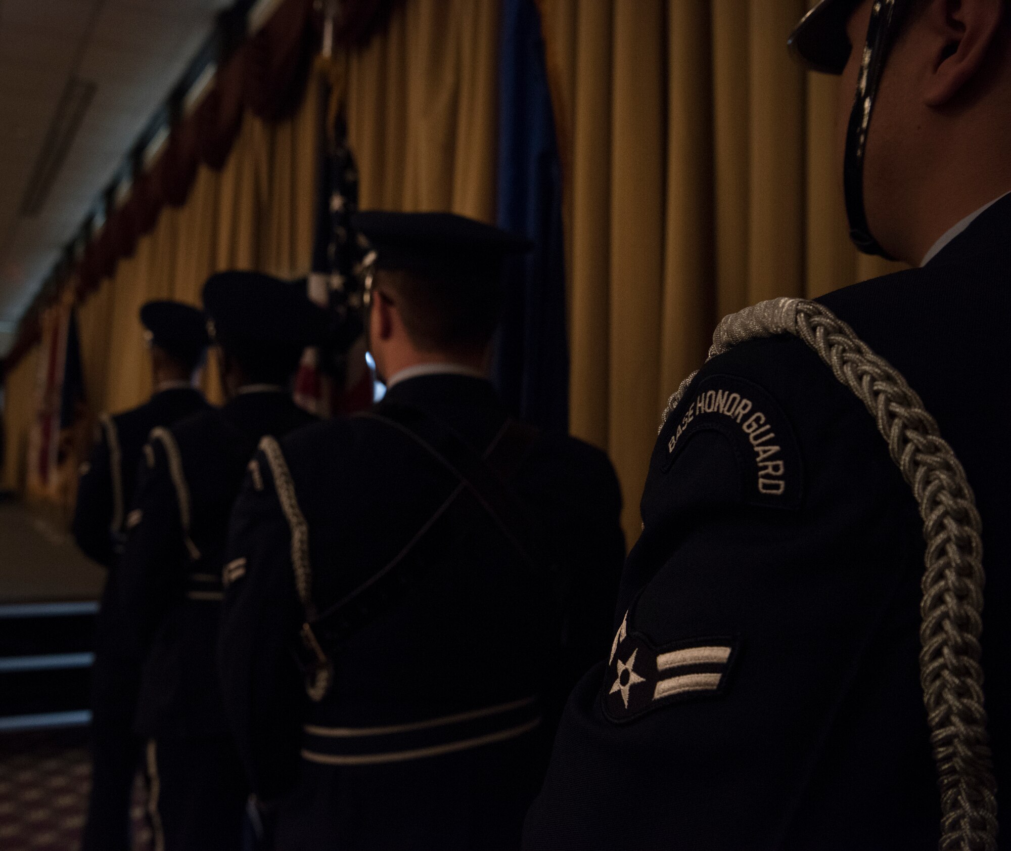 Members of the U.S. Air Force Honor Guard from Joint Base McGuire-Dix-Lakehurst, N.J., stand at attention presenting the colors at the 2018 National Prayer Luncheon at Tommy B’s Community Activities Center here, April 3, 2018. The Honor Guard participates in numerous events to promote the mission, standards, image, and heritage of the U.S. Air Force. (U.S. Air Force photo by Airman Ariel Owings)