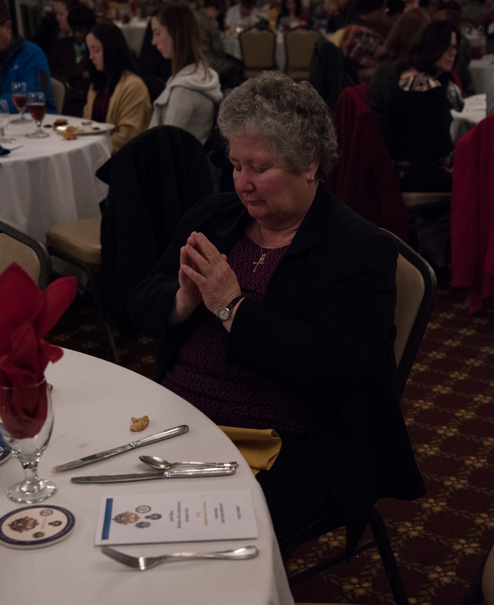 A participant bowed her head in prayer for a blessing during the 2018 National Prayer Luncheon at Tommy B’s Community Activities Center on Joint Base McGuire-Dix-Lakehurst, N.J., April 3, 2018. Military members and their families of all faiths gathered at Tommy B’s to celebrate the variety of religious support the military has to offer its service members and to pray for America and it’s spiritual needs. (U.S. Air Force photo by Airman Ariel Owings)