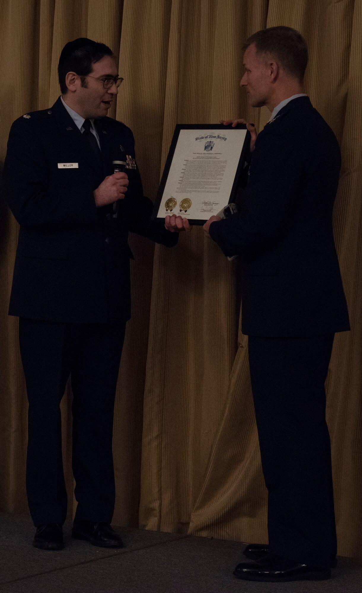 U.S. Air Force Chaplain (Maj. Gen.) Dondi E. Costin, chief of chaplains, receives the New Jersey State Senate Resolution signed by Senator Robert W. Singer of the 30th Legislative District during the 2018 National Prayer Luncheon at Tommy B’s Community Activities Center on Joint Base McGuire-Dix-Lakehurst, N.J., April 3, 2018. Costin was a distinguished guest speaker at the Luncheon to celebrate Joint Base ministry. (U.S. Air Force photo by Airman Ariel Owings)