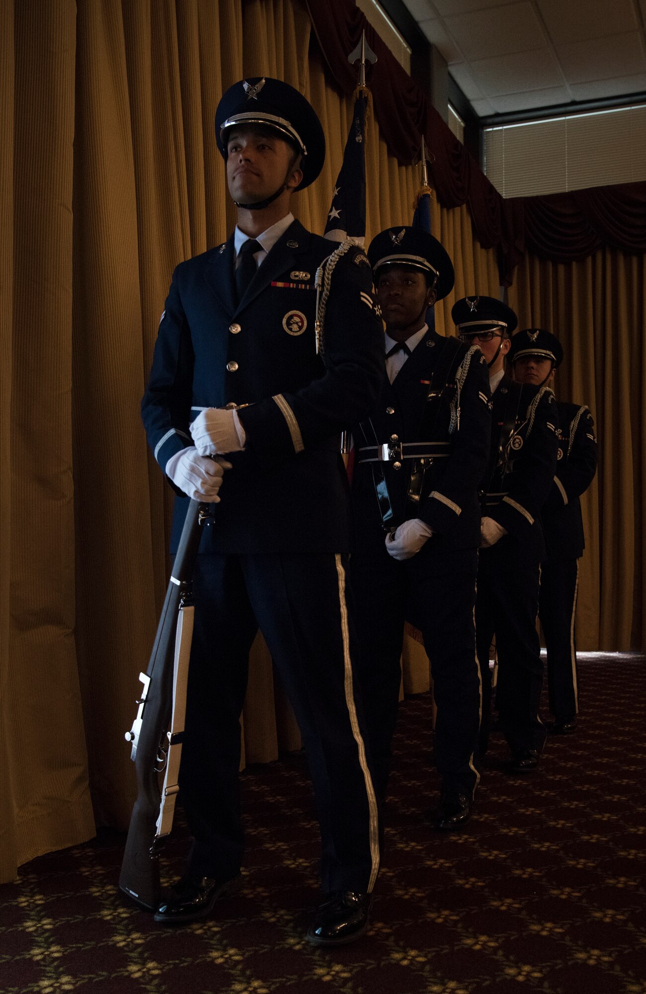 Members of the U.S. Air Force Honor Guard from Joint Base McGuire-Dix-Lakehurst, N.J., prepare to present the colors before the national anthem at the 2018 National Prayer Luncheon at Tommy B’s Community Activities Center here, April 3, 2018. The National Prayer Luncheon was hosted at Joint Base MDL to celebrate joint base ministry. (U.S. Air Force photo by Airman Ariel Owings)