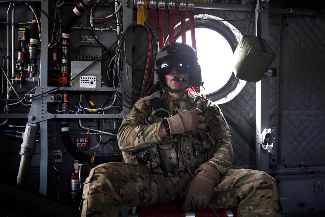 A soldier flies aboard a CH-47F Chinook helicopter.