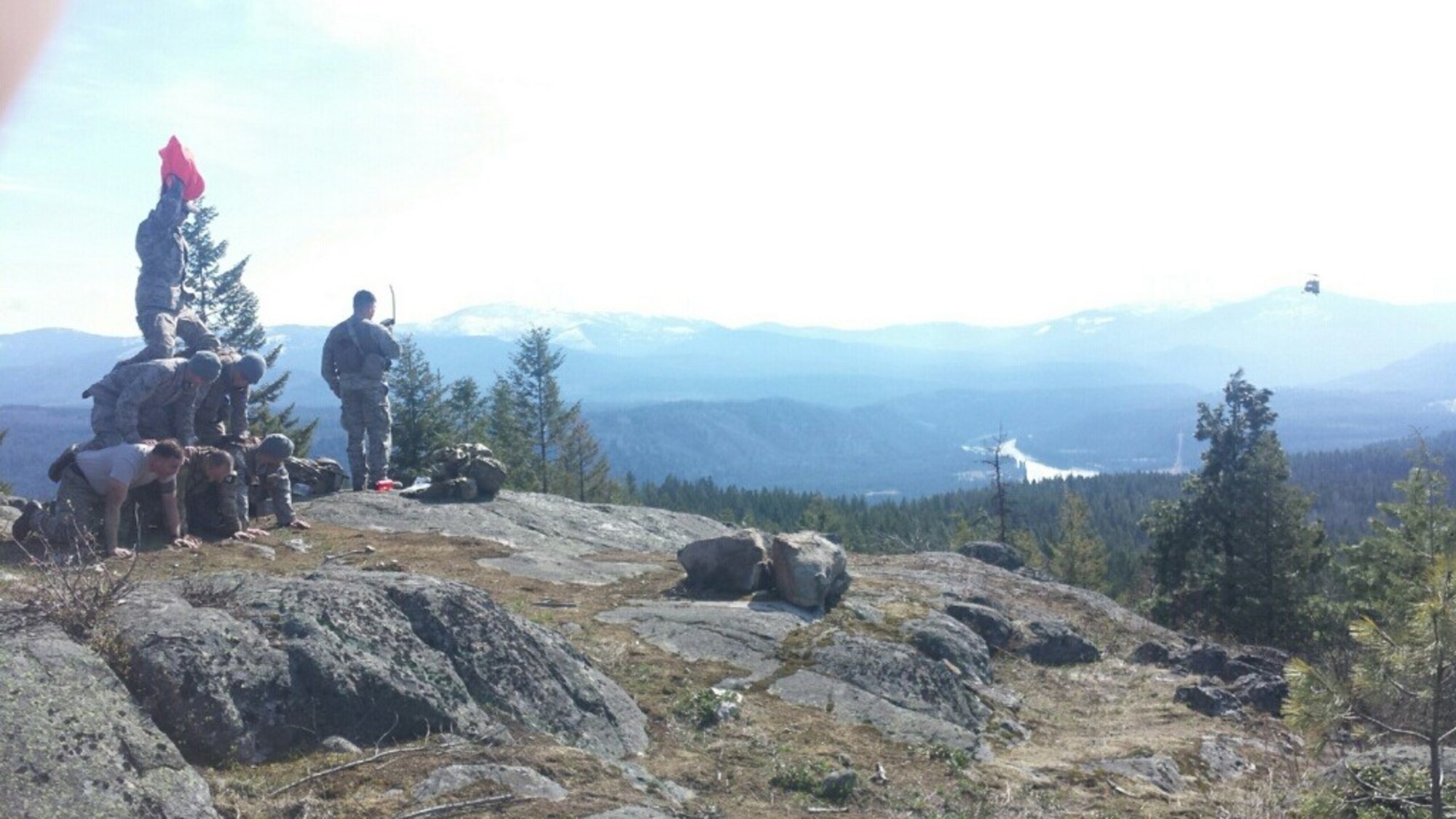 Ruby Creek Training Area, North of Fairchild AFB. The 'isolated person' communicating on the Combat Survivor Evader Locator radio guides recovery to their location. The rescue asset was inbound and required additional authentication via means of a three-person tall, three-person wide pyramid. All of this was accomplished on a navigation day in survival training. Featured in the photo with students are SERE Specialists Tech. Sgt. Douglas Gassner, Staff Sgt. John Ware, and Staff Sgt. Ryan Torres.