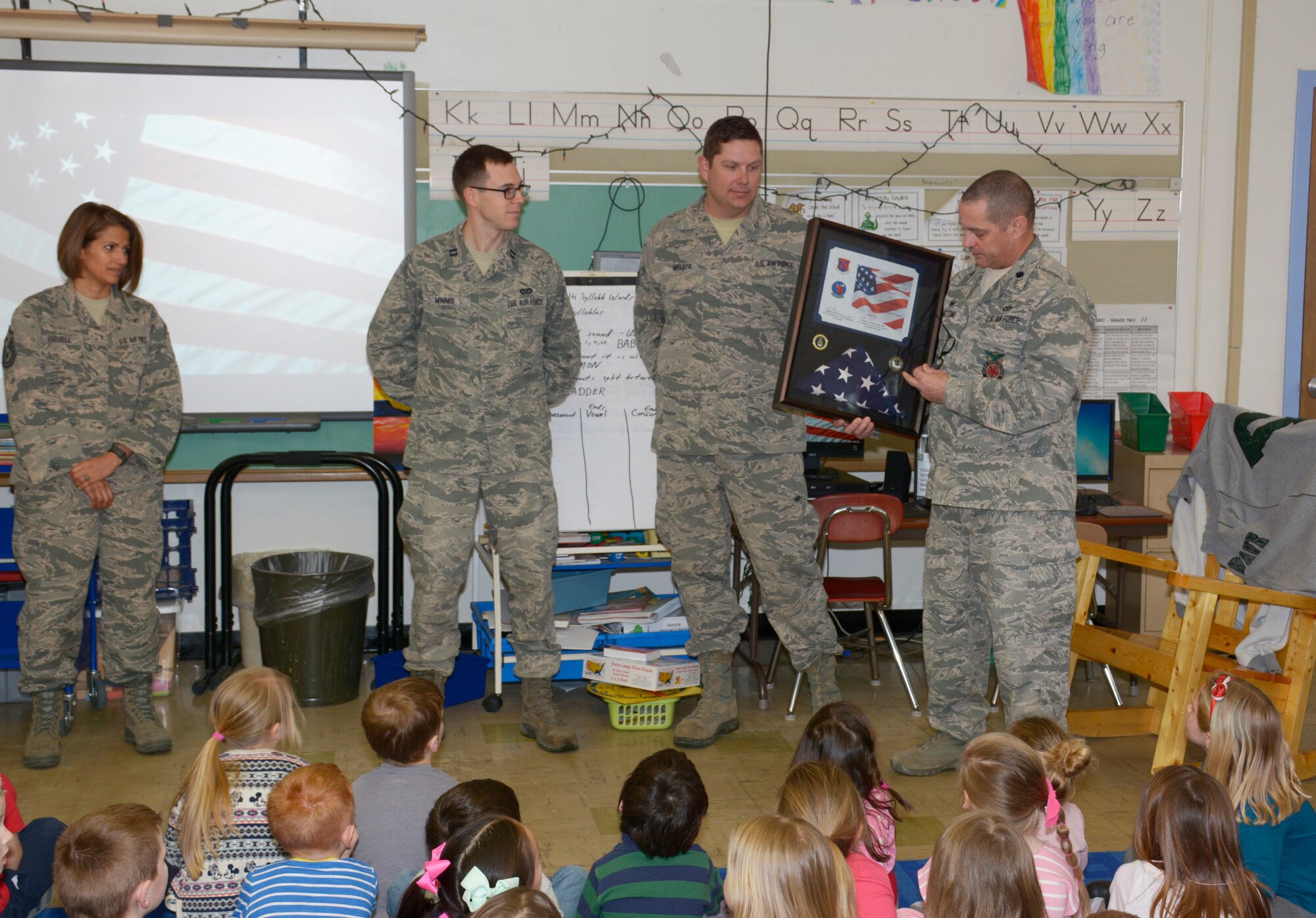 Lt. Col. Eugene R. Mozzoni, 157th Civil Engineer Squadron commander, thanks students at the Garrison Elementary School in Dover, N.H. March 30, 2018. Mozoni presented a flag and certificate to the students during a ceremony thanking the students for sending letters to the engineers while they were deployed to the Middle East. The flag was flown over the country of Kuwait during the last holiday season. (N.H. Air National Guard photo by Master Sgt. Thomas Johnson)