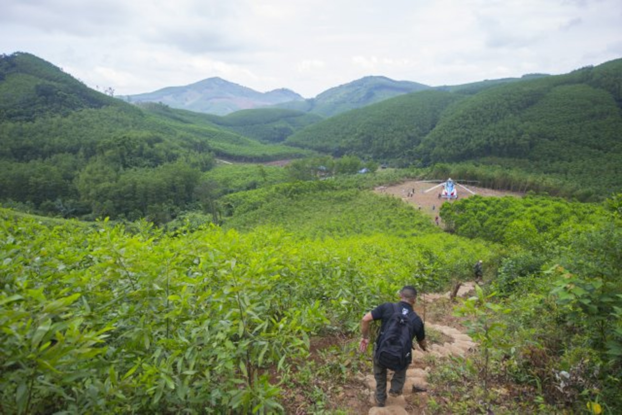 A member of the Defense POW/MIA Accounting Agency hikes a trail down from an excavation site March 17, 2018, in Quang Ngai province, Vietnam, where an American pilot crashed during the Vietnam War. A joint recovery team climbed 700 feet in elevation along a half-mile trail every day to the site as part of the mission. (U.S. Army photo by Sean Kimmons)