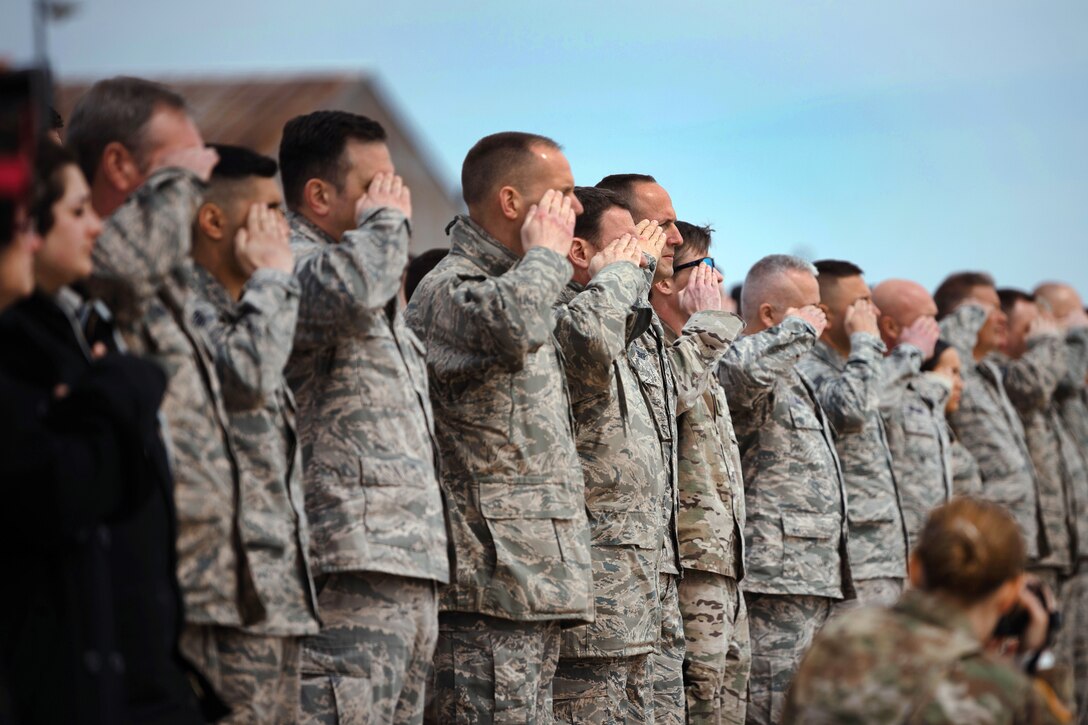 Airmen salute during a dignified arrival.