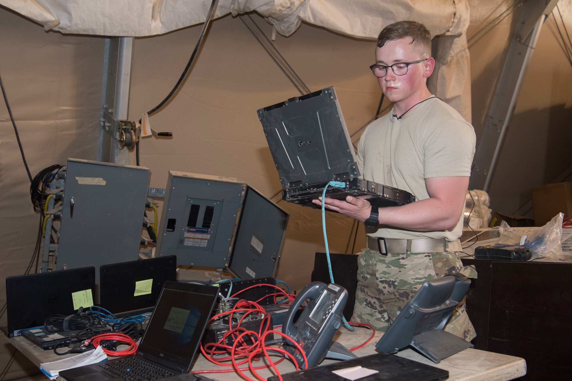 Airman 1st Class Riley Warren, 332nd Expeditionary Communications Squadron cyber transport technician and native of Fort Worth, Texas, uses a communication flyaway kit to set up communication ability as part of an exercise March 22, 2018, at an undisclosed location in Southwest Asia.