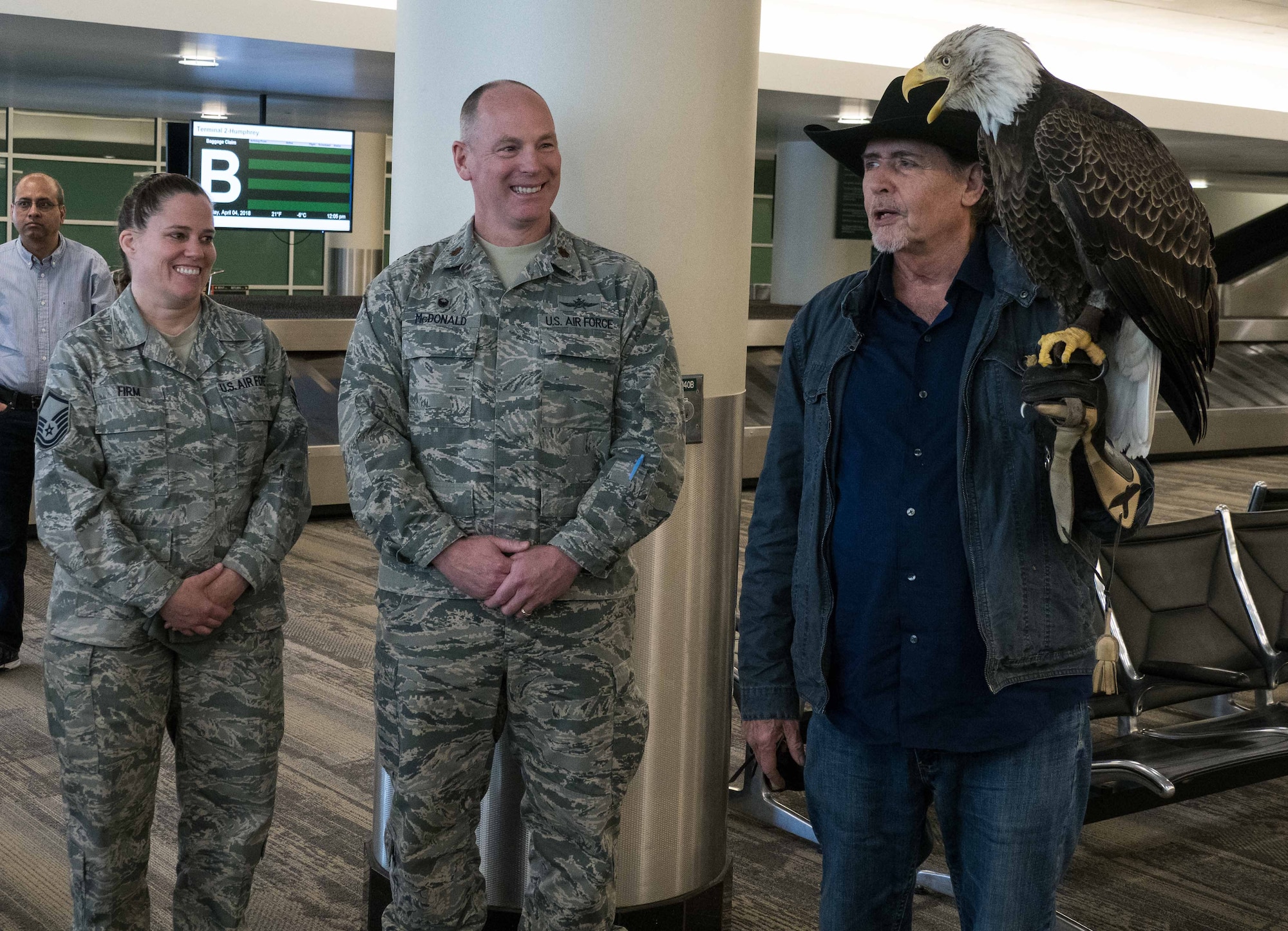 Maj. Pat McDonald And Master Sgt. Christy Firm, 934th Communications Squadron commander, greets Al Louis Cecere, Founder and President of the American Eagle Foundation, and Challenger the Eagle at the Minneapolis-St. Paul International Airport April 4.  Challenger will fly during the national anthem at the Minnesota Twins opening day April 5. (Air Force Photo/Paul Zadach)