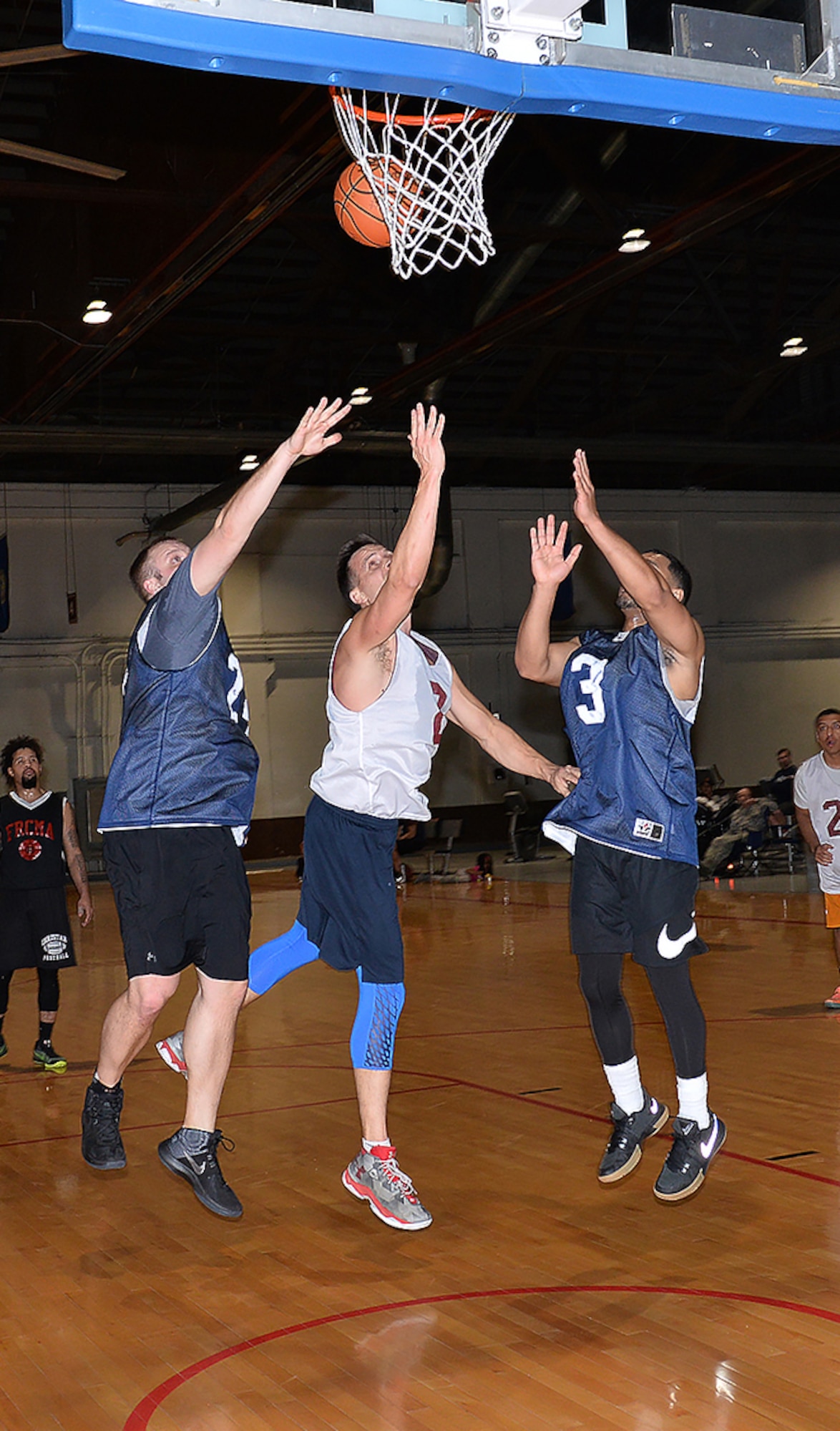 John Bone, a forward on the 20th Intelligence Squadron basketball team and a major with the 55th Wing Judge Advocate office, makes a layup while two defenders from the 595th Aircraft Maintenance Squadron try and stop him during the 2018 Offutt Intramural Basketball championship at the Offutt Field House April 5. Bone led all scorers with 25 in the title game. (U.S. Air Force photo by Charles Haymond)