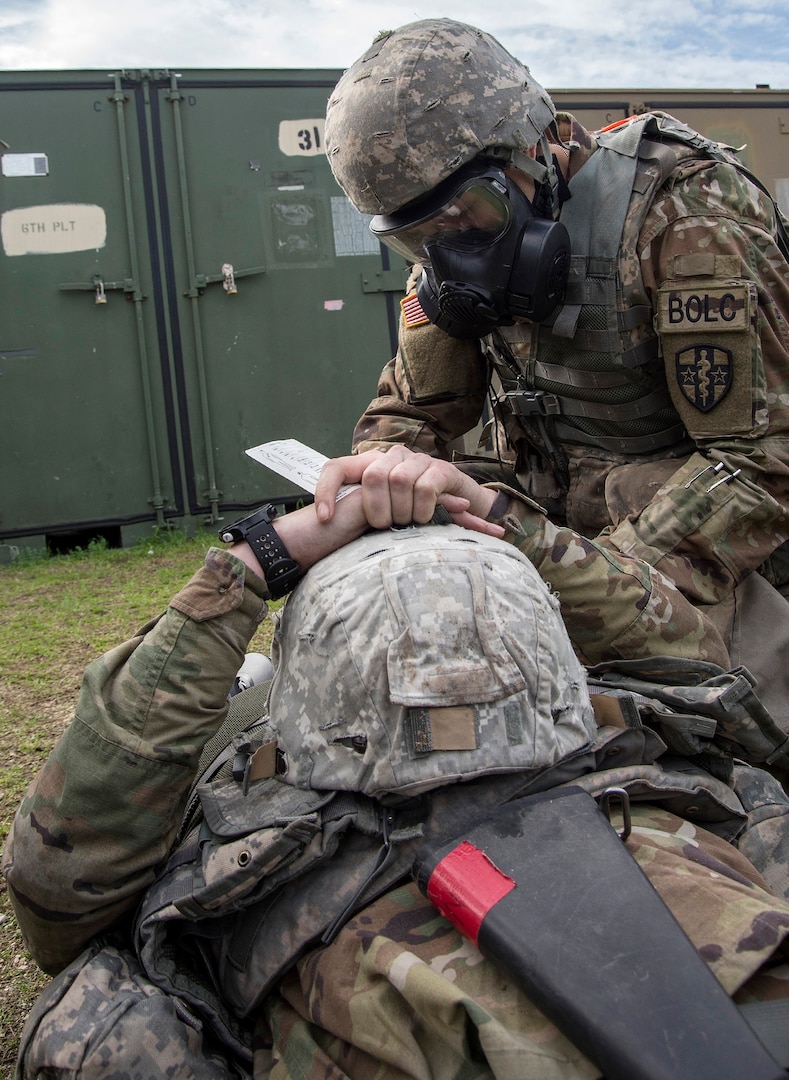 A student in the U.S. Army Medical Department Center & School Basic Officer Leader Course, or BOLC, helps treat a “wounded” service member during a simulated tactical exercise Feb. 26 at Joint Base San Antonio-Fort Sam Houston. BOLC is the entry-level course for students who are becoming commissioned officers in the Army and is conducted in two phases over seven weeks, including classroom training and field training. The objective of the course is to train new officers in Army tasks and familiarize them with the AMEDD culture.