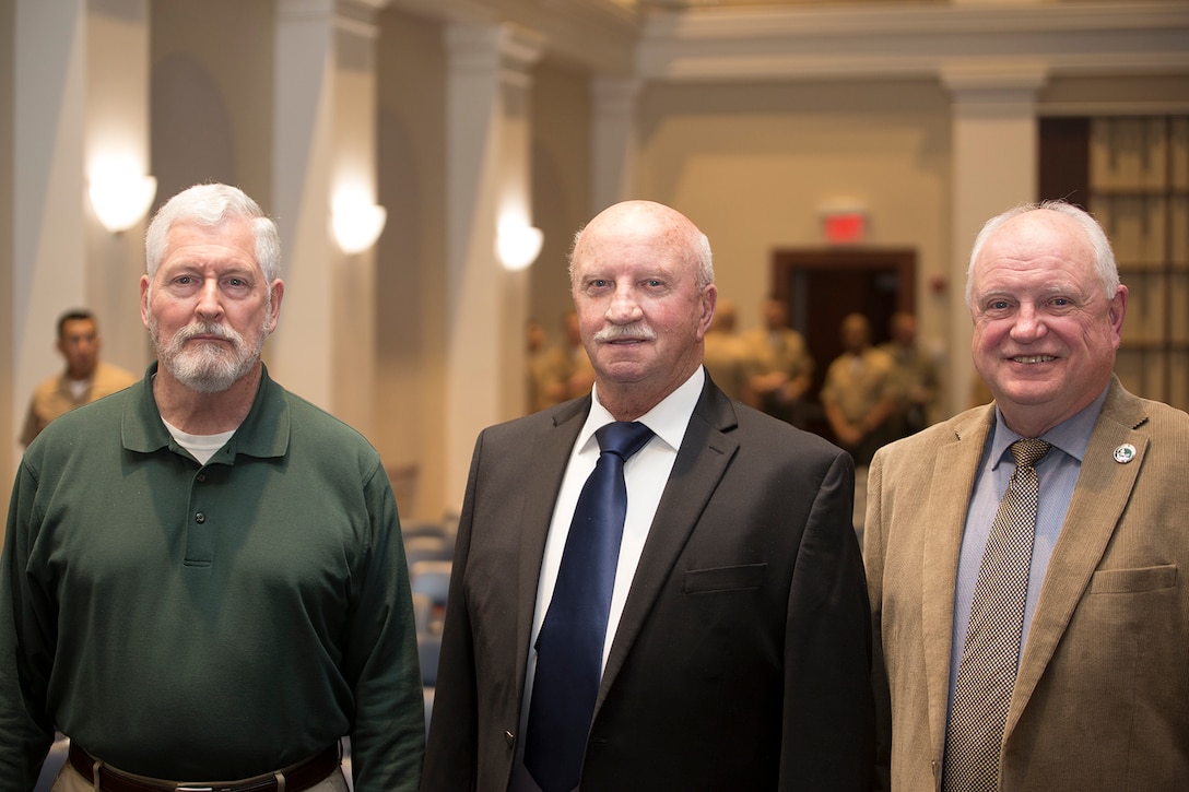 The 4th Color Sergeant of the Marine Corps, Bob Brothers, right, the 5th Color Sergeant of the Marine Corps, Michael Kane, left, and a former United States Marine Corps Color Guard Marine, Thomas Flattery, pose for a photo following the Color Sergeant of the Marine Corps relief and appointment ceremony at Marine Barracks Washington D.C., April 6, 2018. The former Color Guard Marines attended the ceremony to witness the passing of duties and responsibilities from one Color Sergeant to the next. (Official U.S. Marine Corps photo by Pfc. James Bourgeois/Released)