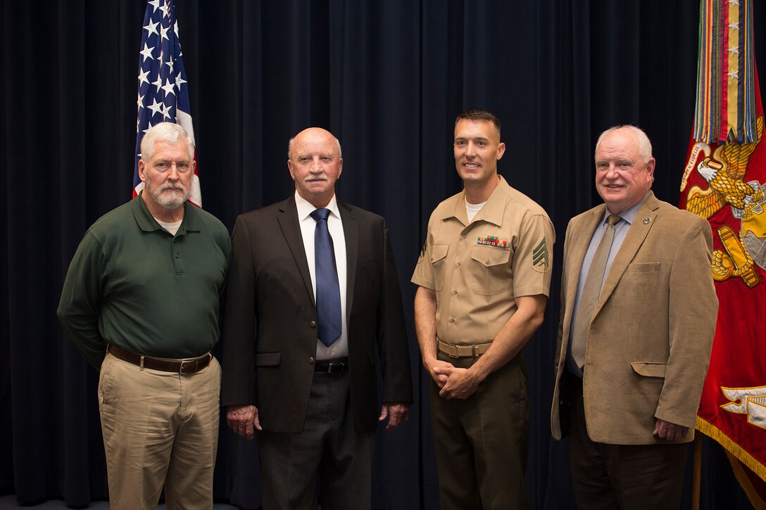 Sergeant Kenneth Newton, the 37th Color Sergeant of the Marine Corps, poses for a photo with the 4th and 5th Color Sergeants of the Marine Corps, as well as a former Color Guard Marine, at the conclusion of a relief and appointment ceremony at Marine Barracks Washington D.C., April 6, 2018. The former Color Guard Marines attended the ceremony to witness the passing of duties and responsibilities from one Color Sergeant to the next. (Official U.S. Marine Corps photo by Pfc. James Bourgeois/Released)