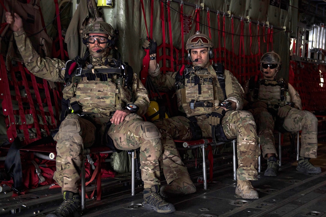 Airmen fly inside a C-130J Super Hercules aircraft.