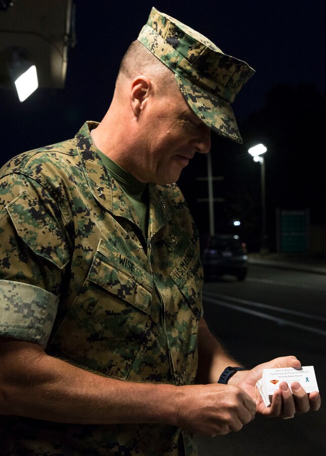Maj. Gen. Mark R. Wise, commanding general of 3rd Marine Aircraft Wing, hands out Sexual Assault Awareness and Prevention Month cards at the entrance of Marine Corps Air Station Miramar, Calif., April 4. 3rd Marine Aircraft Wing and MCAS Miramar support efforts to create military communities free from sexual violence and assault. (U.S. Marine Corps photo by Lance Cpl. Clare J. McIntire/ Released)