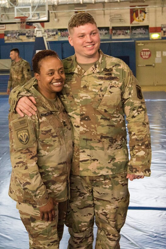 Retired Army Sgt. Franz Walkup poses for a photo with Pennsylvania Army National Guard Sgt. Maj. Stephanie Armstrong, following an Operation Proper Exit town hall meeting at Camp Arifjan, Kuwait.