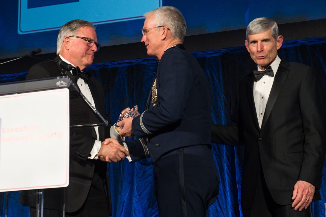Air Force Gen. Paul J. Selva, vice chairman of the Joint Chiefs of Staff, is given an award on stage.