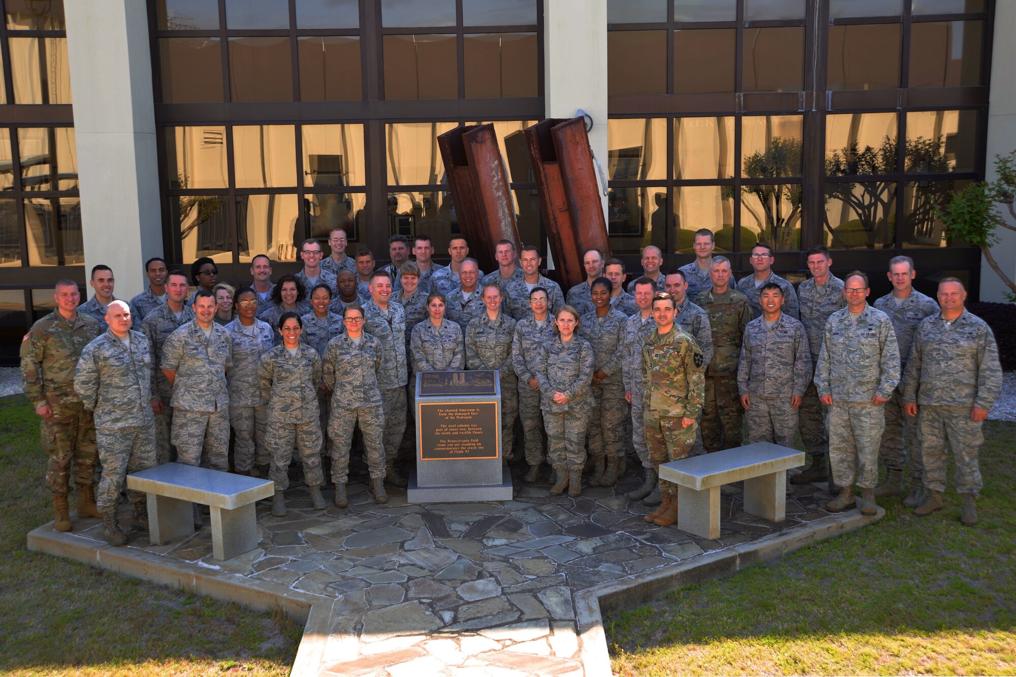 Military staff judge advocates and enlisted legal staff members pause for a photo in front of the 9/11 Memorial during their visit to the 601st Air Operations Center March 27. (Air National Guard photo by Maj. Andrew Scott)