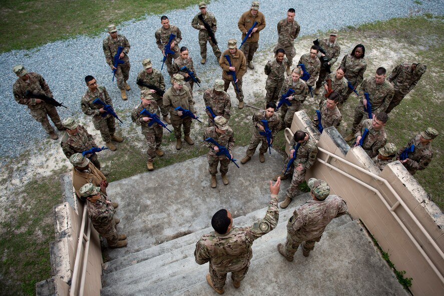 Airman from the 824th Base Defense Squadron get briefed during dismounted training operations, March 26, 2018, at Moody Air Force Base, Ga. The operations conducted were a part of the 820th Base Defense Group’s (BDG) Initial Qualification Training, which is given to new Airmen coming into the BDG as an opportunity to learn a baseline of basic combat skills that will be needed to successfully operate as a cohesive unit while in a deployed environment. (U.S. Air Force photo by Airman 1st Class Erick Requadt)
