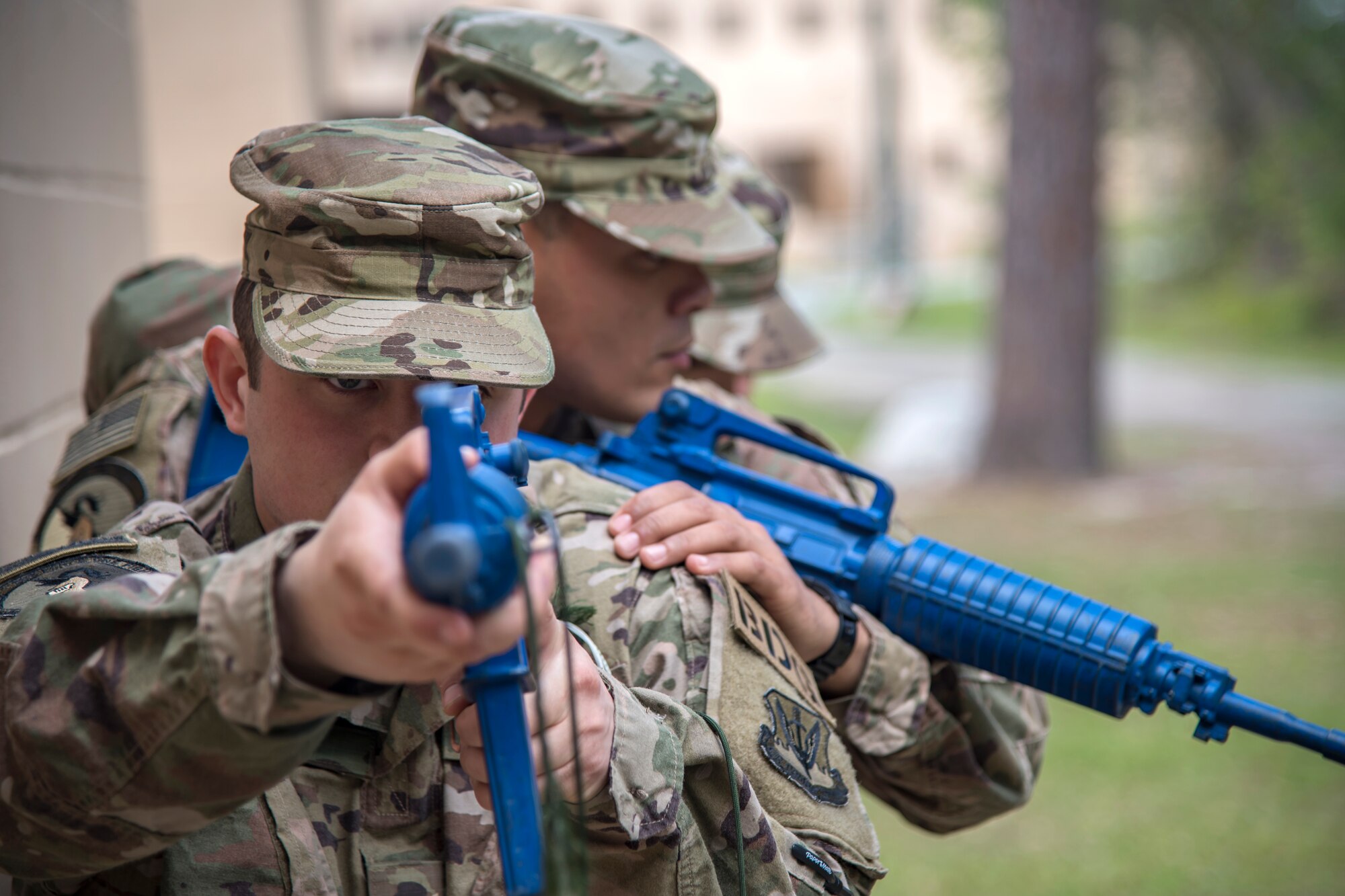 Airmen from the 820th Base Defense Group (BDG), prepare to advance their position during dismounted operations training, March 27, 2018, at Moody Air Force Base, Ga. The dismounted ops training is part of an Initial Qualification Training, which gives new Airmen coming into the BDG an opportunity to learn a baseline of basic combat skills that will be needed to successfully operate within a cohesive unit while in a deployed environment. (U.S. Air Force photo by Airman Eugene Oliver)