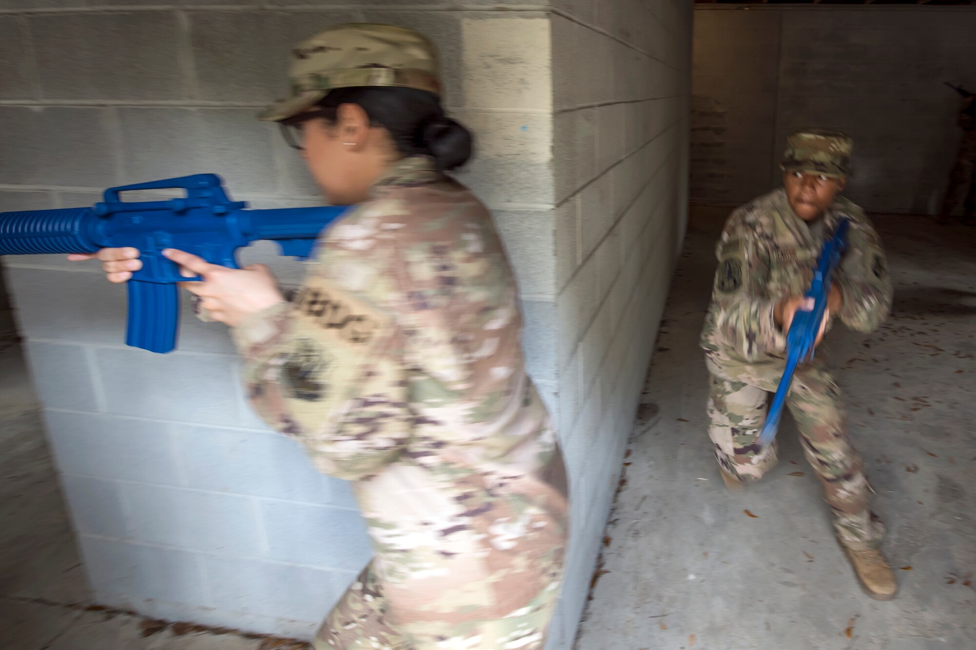 Airman 1st Class Kierra Carter, 824th Base Defense Squadron fireteam member, right, prepares to round a corner during dismounted operations training, March 27, 2018, at Moody Air Force Base, Ga.  The dismounted ops training is part of an Initial Qualification Training, which gives new Airmen coming into the 820th Base Defense Group an opportunity to learn a baseline of basic combat skills that will be needed to successfully operate within a cohesive unit while in a deployed environment. (U.S. Air Force photo by Airman Eugene Oliver)