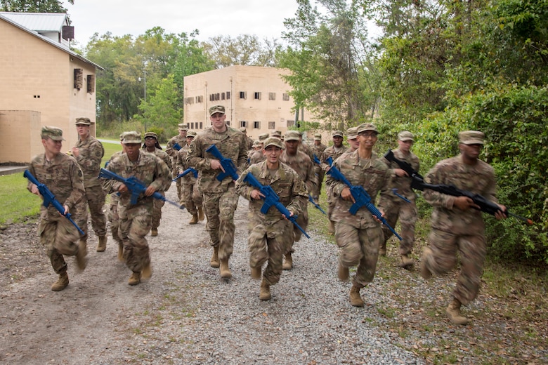 Airmen from 820th Base Defense Group (BDG), run as a group following dismounted operations training, March 27, 2018, at Moody Air Force Base, Ga. The dismounted ops training is part of an Initial Qualification Training, which gives new Airmen coming into the BDG an opportunity to learn a baseline of basic combat skills that will be needed to successfully operate within a cohesive unit while in a deployed environment. (U.S. Air Force photo by Airman Eugene Oliver)