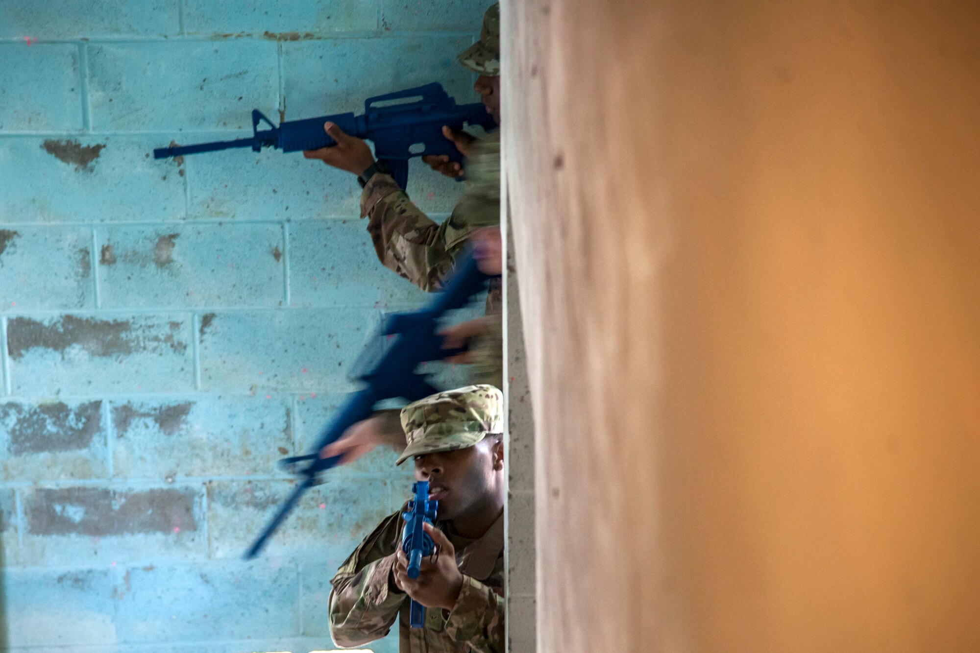 Airman Treyshaun Burnett, 824th Base Defense Squadron fireteam member, front, provides simulated cover fire for his fellow airmen while they enter a building during dismounted operations training, March 27, 2018, at Moody Air Force Base, Ga. The dismounted ops training is part of an Initial Qualification Training, which gives new Airmen coming into the 820th Base Defense Group an opportunity to learn a baseline of basic combat skills that will be needed to successfully operate within a cohesive unit while in a deployed environment. (U.S. Air Force photo by Airman Eugene Oliver)
