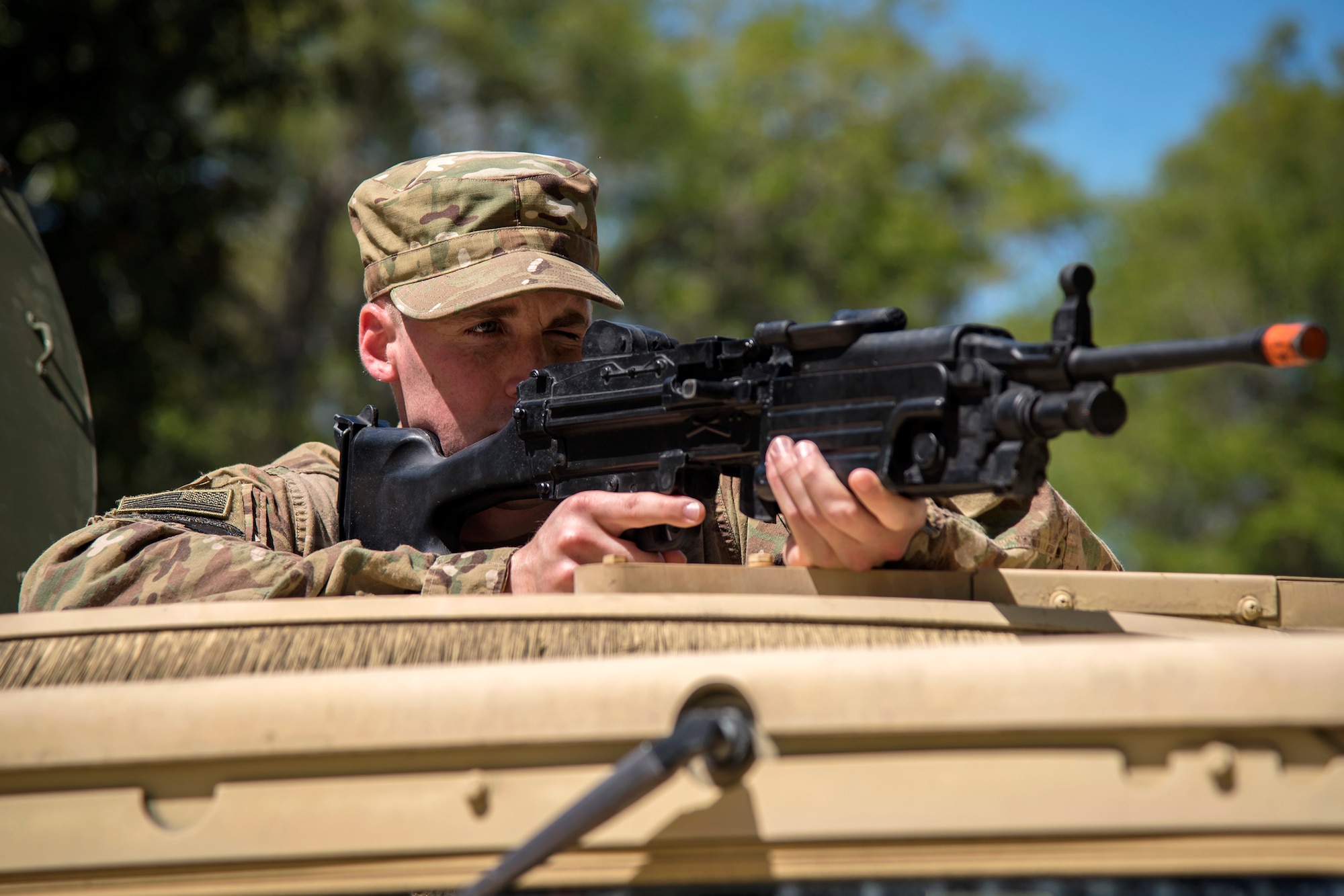 Airman 1st Class Alexander Moore, 824th Base Defense Squadron fireteam member, aims down the sight of a simulated weapon from the turret position of a Humvee during vehicle operations training, March 28, 2018, at Moody Air Force Base, Ga. The vehicle ops training is part of Initial Qualification Training, which gives new Airmen coming into the 820th Base Defense Group an opportunity to learn a baseline of basic combat skills that will be needed to successfully operate within a cohesive unit while in a deployed environment. (U.S. Air Force photo by Airman Eugene Oliver)