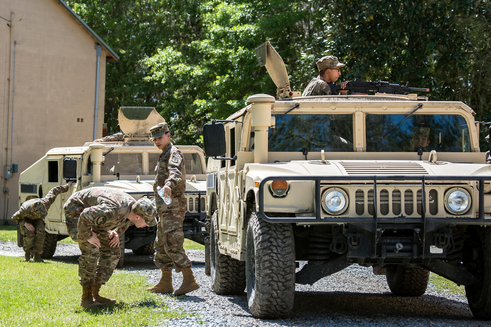 Airmen from the 820th Base Defense Group (BDG), inspect the underbelly of a Humvee during vehicle operations training, March 28, 2018, at Moody Air Force Base, Ga. The vehicle ops training is part of Initial Qualification Training, which gives new Airmen coming into the BDG an opportunity to learn a baseline of basic combat skills that will be needed to successfully operate within a cohesive unit while in a deployed environment. (U.S. Air Force photo by Airman Eugene Oliver)