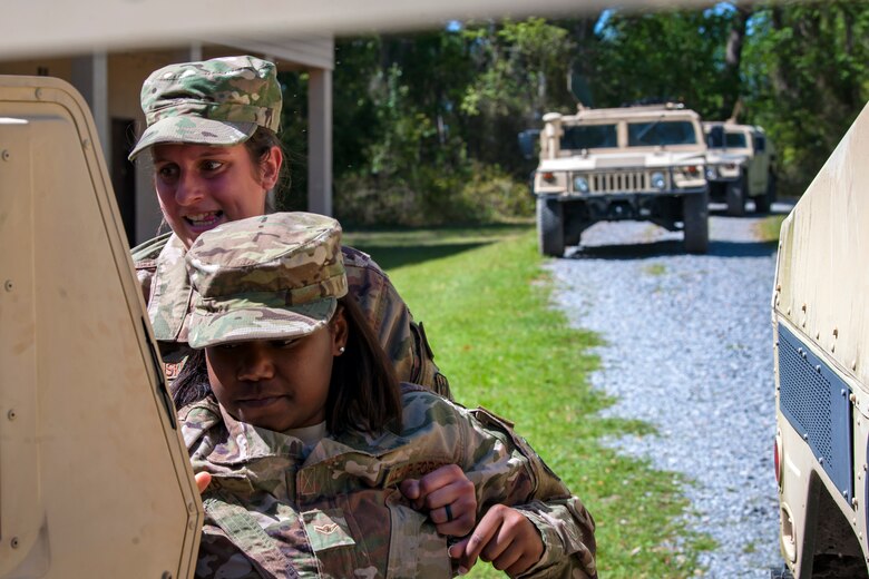 Airman 1st Class Megan Radwanski, 824th Base Defense Squadron fireteam member, rear, carries Airman Jasmine Smith to safety during vehicle operations training, March 28, 2018, at Moody Air Force Base, Ga. The vehicle ops training is part of Initial Qualification Training, which gives new Airmen coming into the 820th Base Defense Group an opportunity to learn a baseline of basic combat skills that will be needed to successfully operate within a cohesive unit while in a deployed environment. (U.S. Air Force photo by Airman Eugene Oliver)