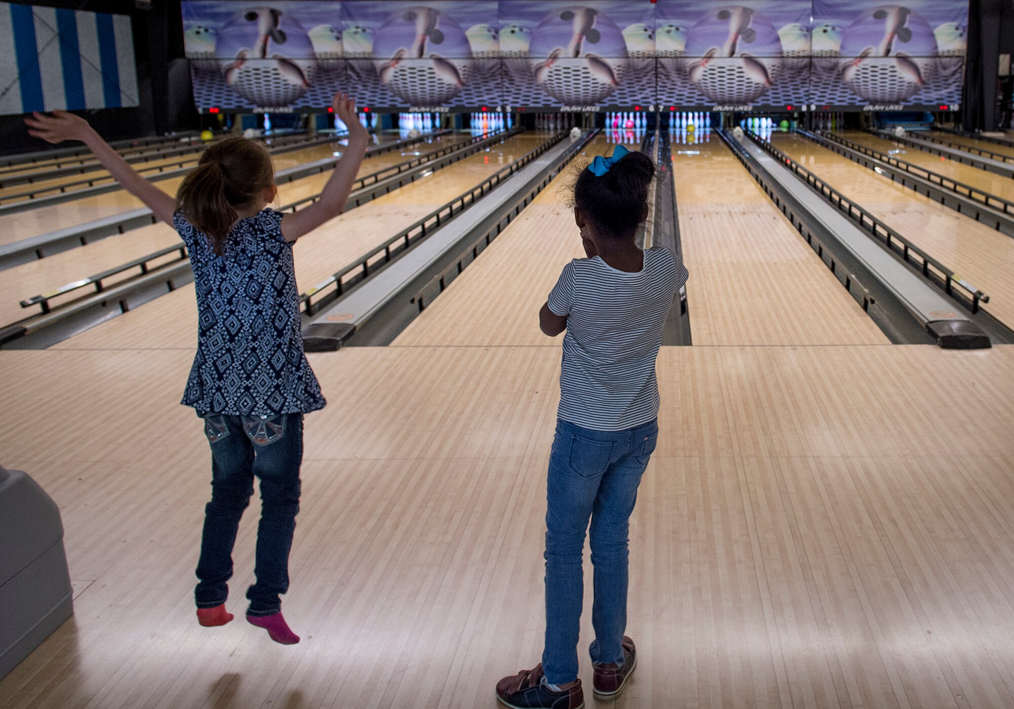 Students from the Altus Air Force Base Youth Center watch to see how many pins they knock down while bowling at the Galaxy Grill and Lanes, April 5, 2018, on Altus AFB, Okla.