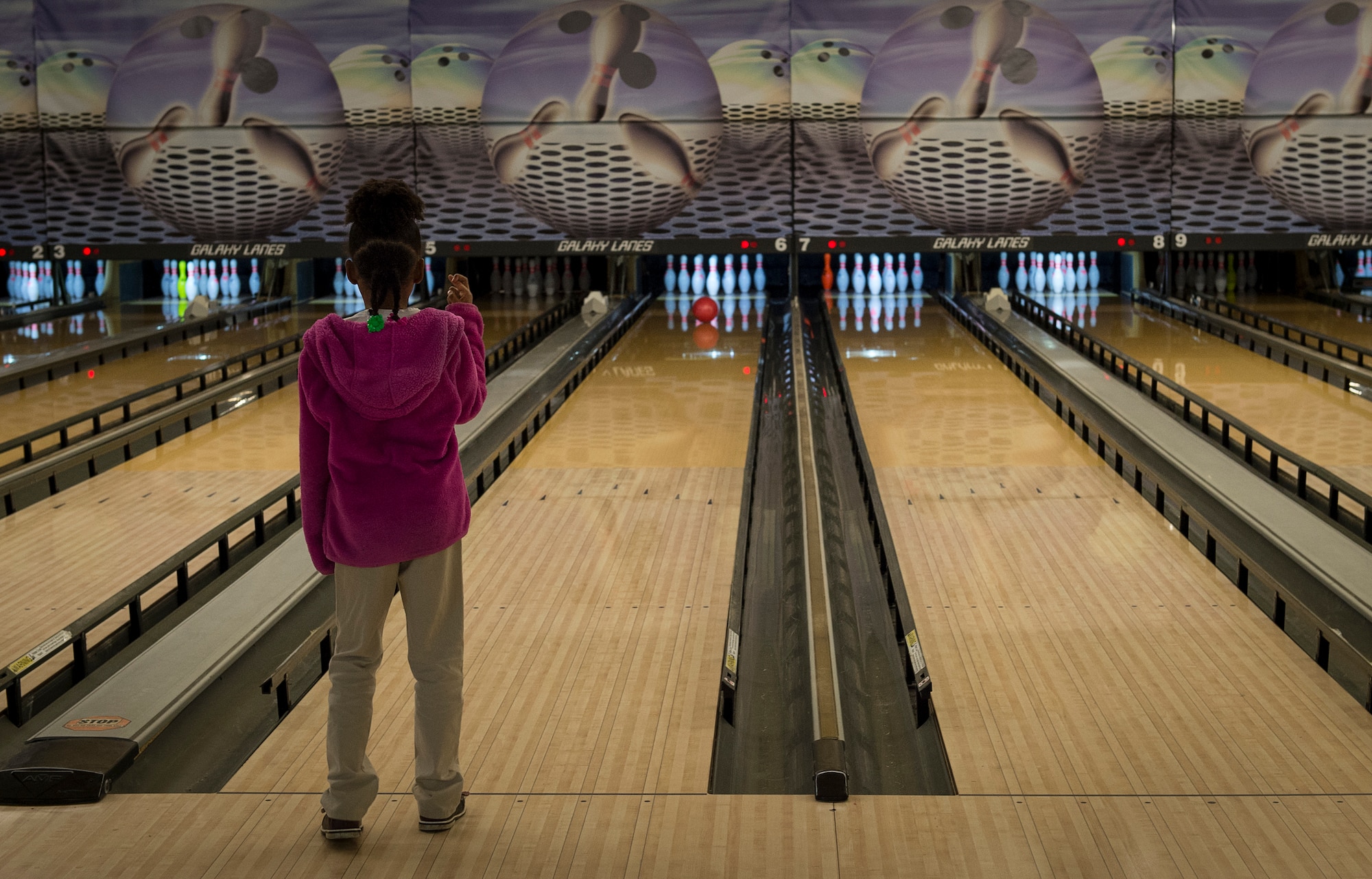 A student from the Altus Air Force Base Youth Center, crosses her fingers while bowling at the Galaxy Grill and Lanes, April 5, 2018, on Altus AFB, Okla.