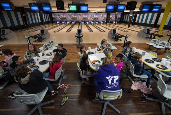 Students from Altus Air Force Base and the local community eat pizza at the Galaxy Grill and Lanes, April 5, 2018, on Altus AFB, Okla.