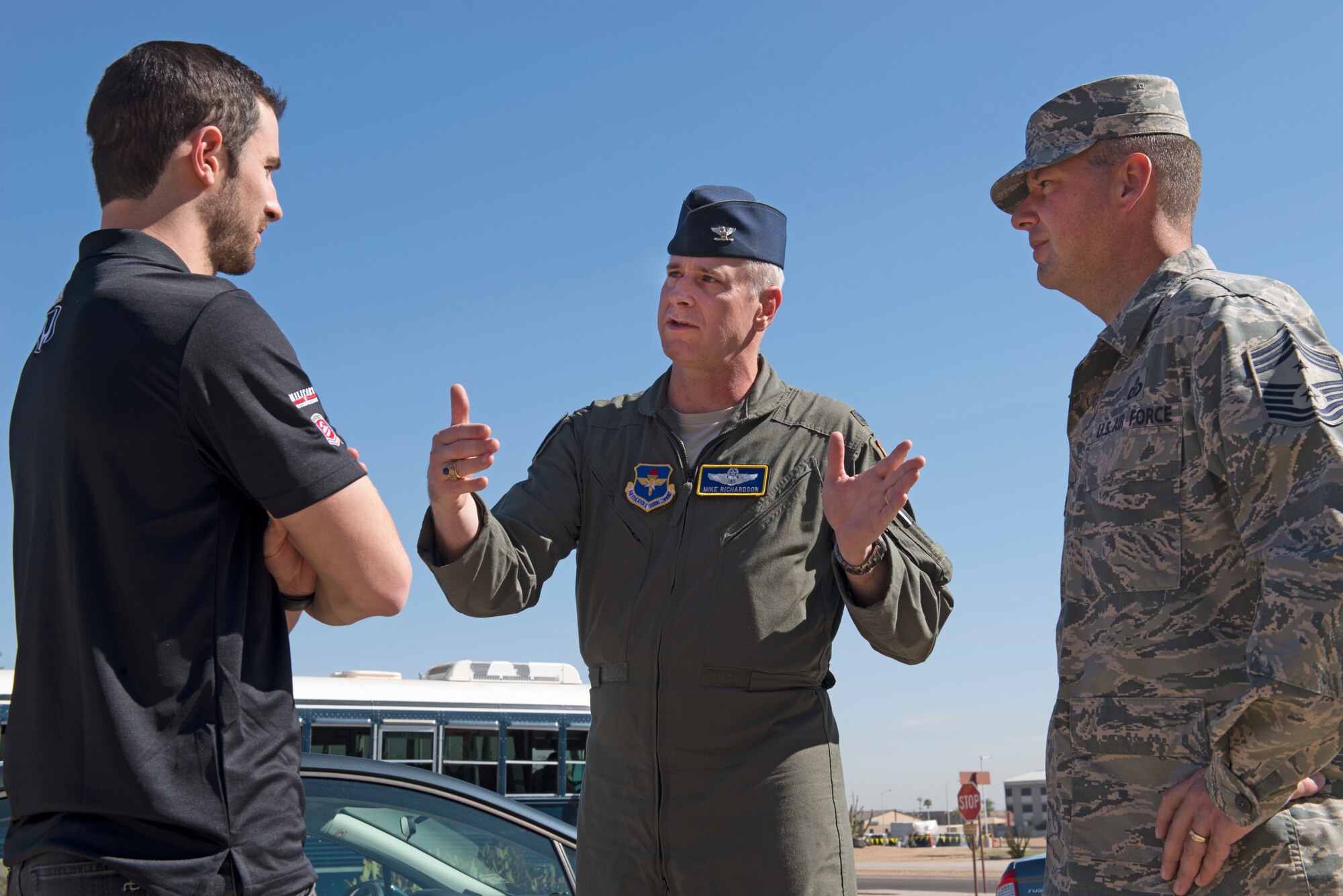 Alexander Rossi, Andretti Autosport racecar driver; Col. Michael Richardson, 56th Fighter Wing vice commander; and Chief Master Sgt. Randy Kwiatkowski, 56th Fighter Wing command chief, talk about aspects of the wing’s mission at Luke Air Force Base, Ariz., April 5, 2018. Rossi visited Luke as part of a small delegation from Andretti Autosport in order to learn about the base and its Airmen. (U.S. Air Force photo by Senior Airman Ridge Shan)