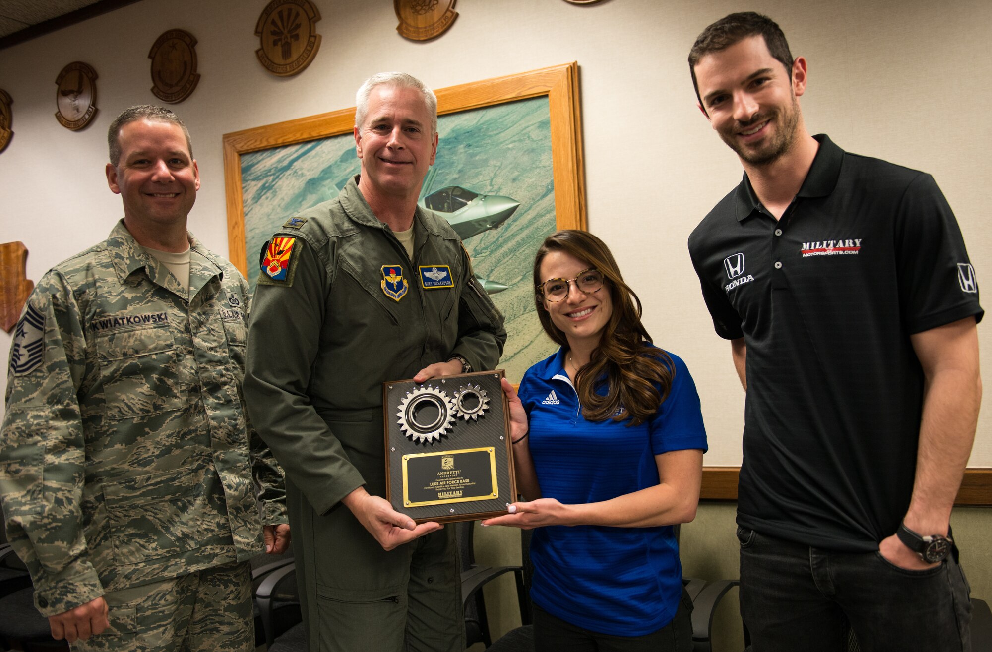 Col. Michael Richardson, 56th Fighter Wing vice commander, receives a gift of appreciation from the Andretti Autosport team at Luke Air Force Base, Ariz., April 5, 2018. The visit provided the Andretti Autosport team insight on the mission of Luke and its Airmen. (U.S. Air Force photo by Airman 1st Class Alexander Cook)