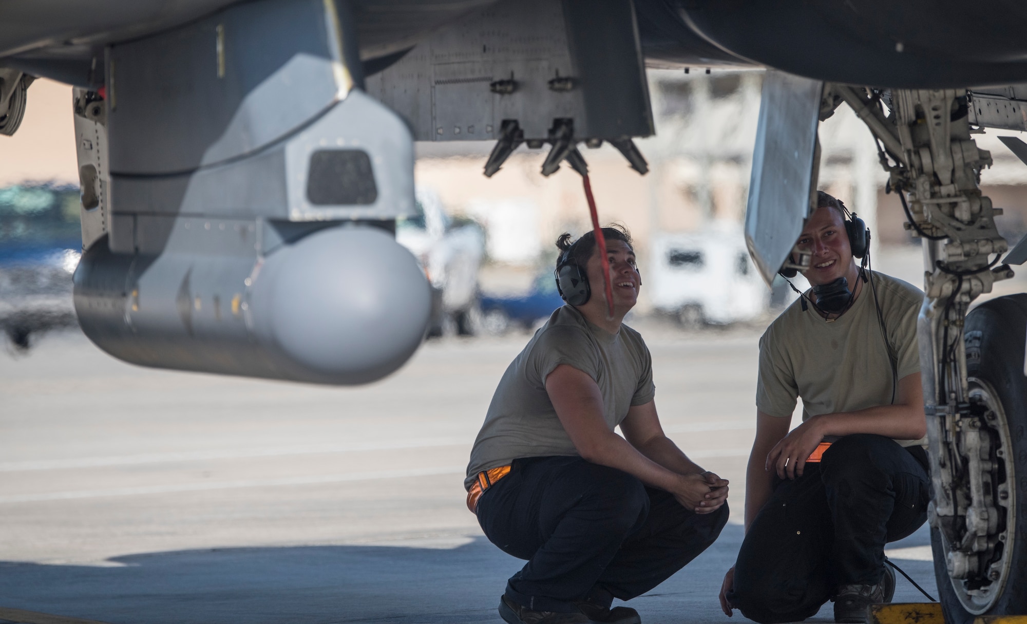 Image of Airman Matthew Ozuzun and Airman 1st Class Leopoldo Jauregoz, 391st Aircraft Maintenance Unit crewchiefs, await the take off of their F-15E Strike Eagle at Tyndall Air Force Base, Florida, April 3, 2018. Combat Archer and Hammer provided the opportunity to evaluate the squadron's ability to perform in a tempo more comparable to a deployed environment. (U.S. Air Force photo by Staff Sgt Jeremy L. Mosier)