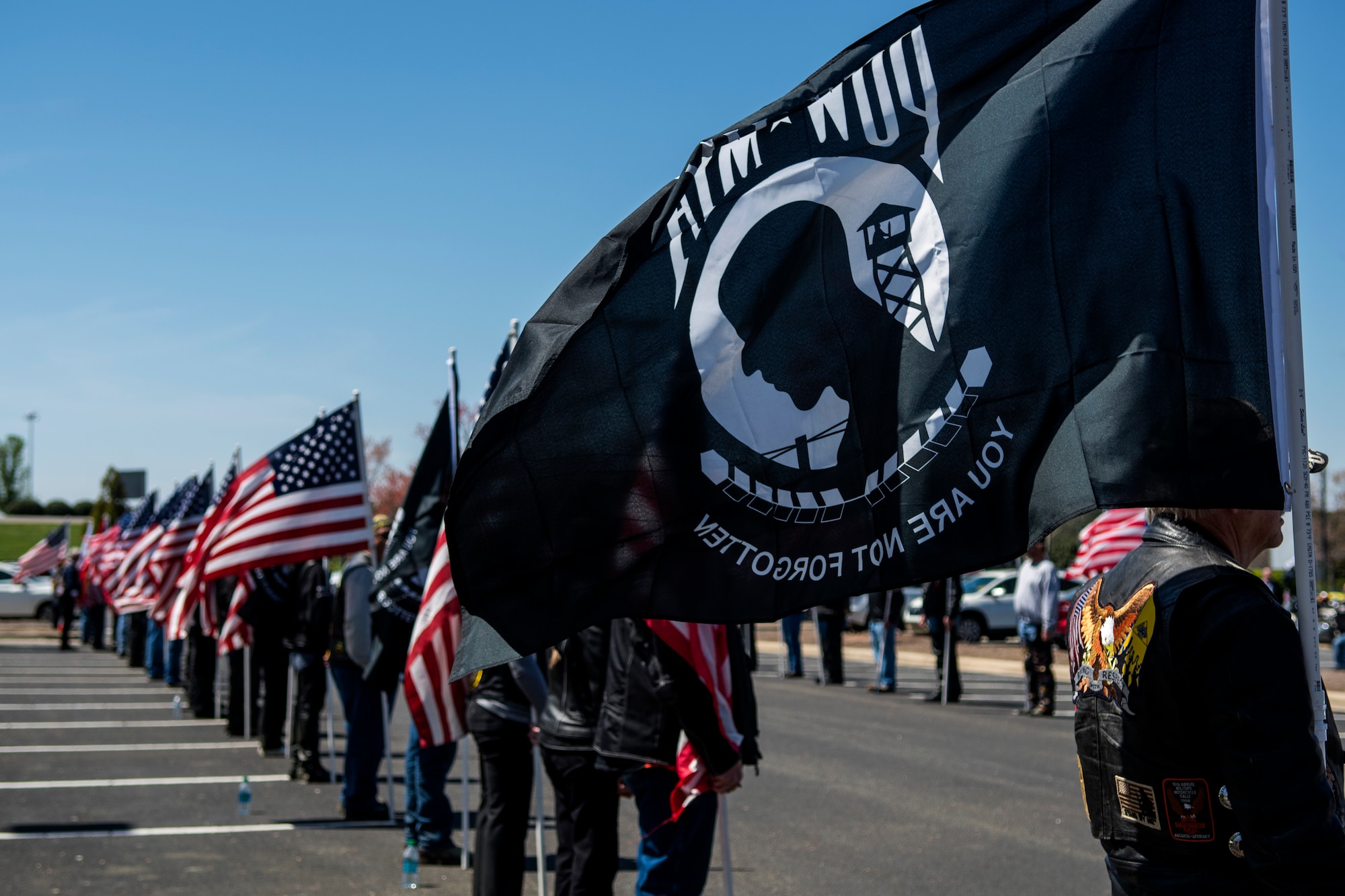 Members of the Patriot Guard Riders of North Carolina stand with American flags and Prisoner-of-War/Missing-in-Action flags to honor the repatriated remains of Col. Edgar “Felton” Davis, April 5, 2018, in Raleigh, North Carolina.