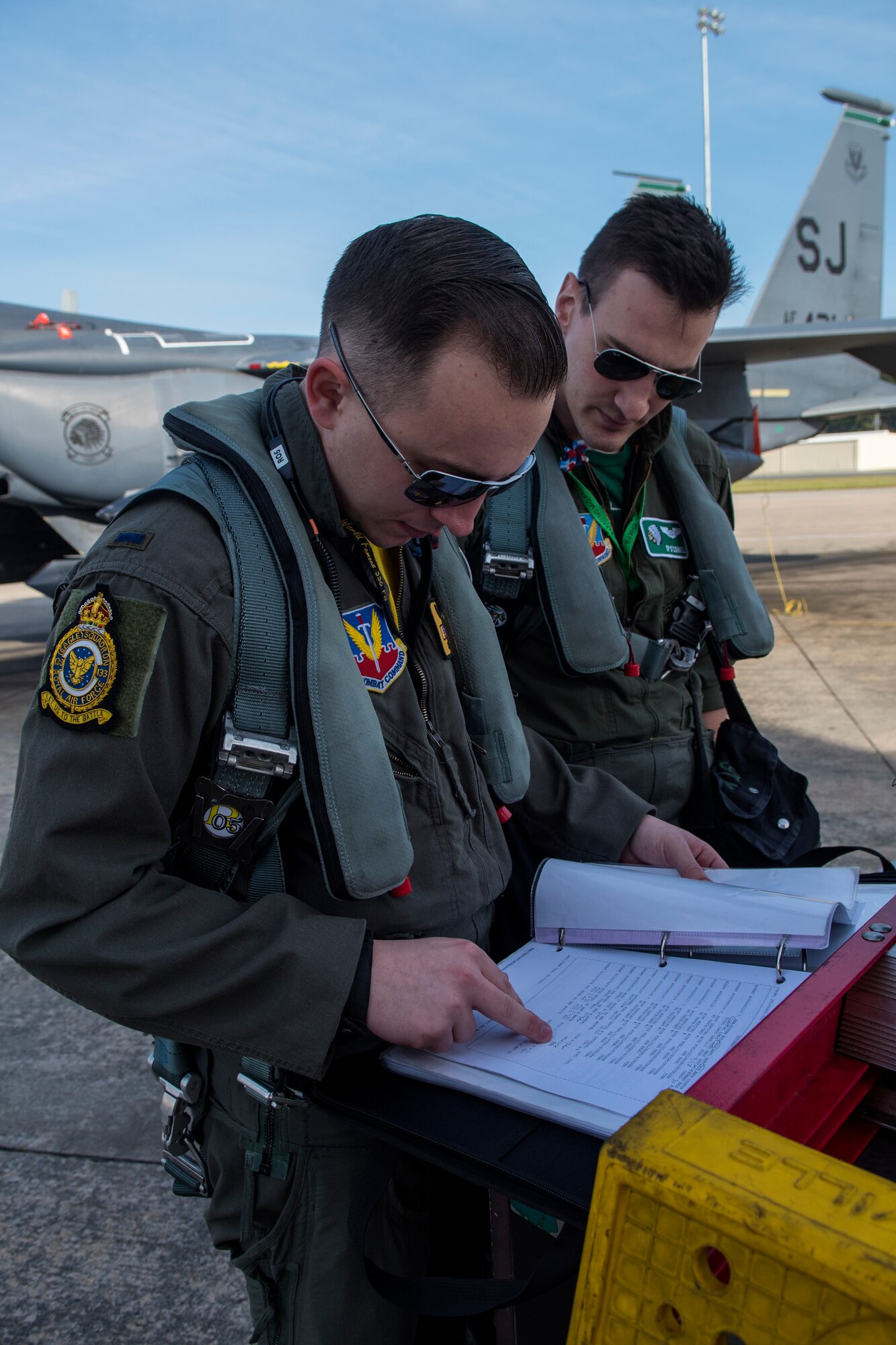 1st Lts. Jacob Del Ponte (left), 336th Fighter Squadron pilot, and Shane O’Connell, 335th Fighter Squadron weapon systems officer, check the maintenance log of an F-15E Strike Eagle prior to take off for Razor Talon, April 6, 2018, at Seymour Johnson Air Force Base, North Carolina.