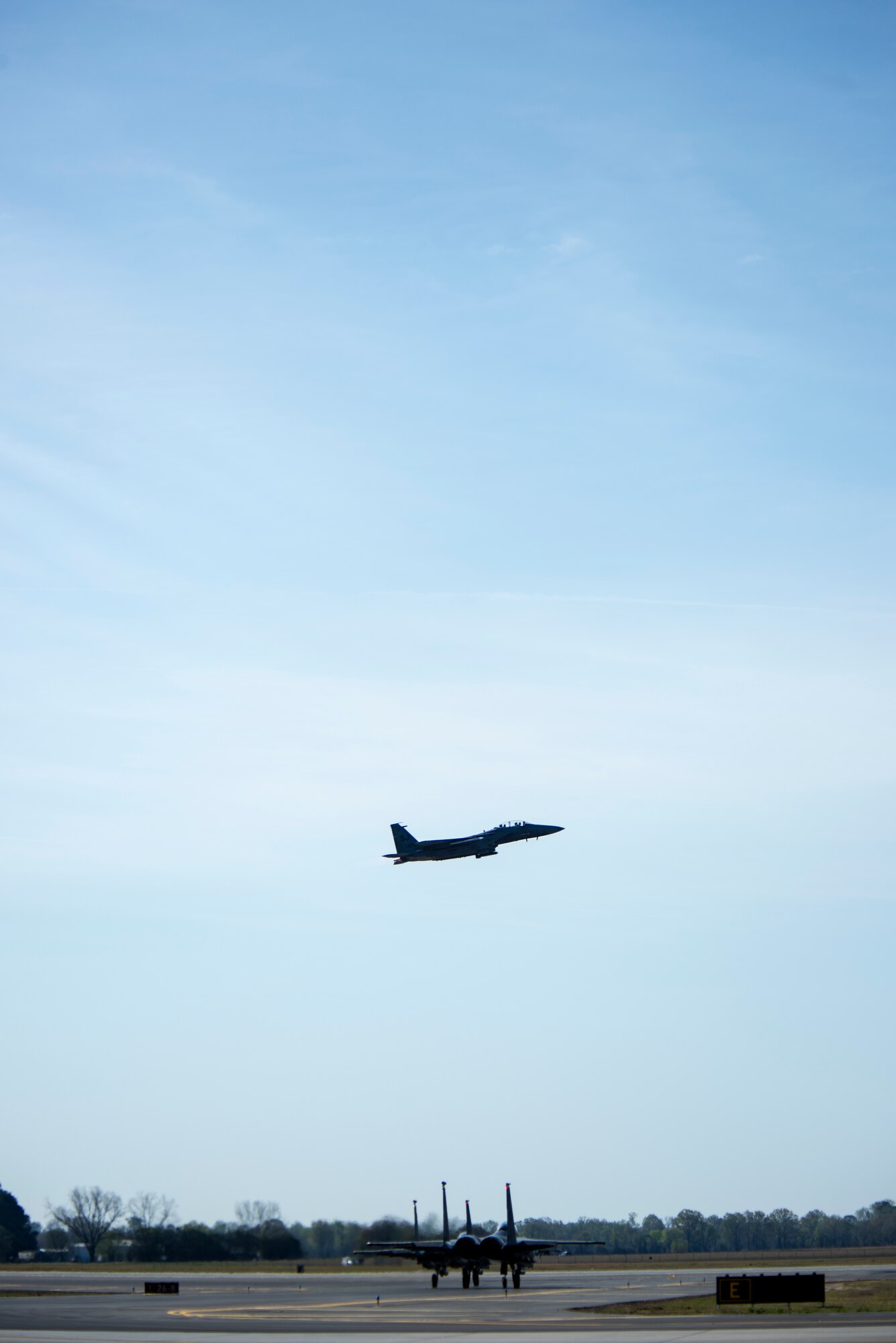 An F-15E Strike Eagle takes off to participate in Razor Talon while another F-15E taxis down the runway, April 6, 2018, at Seymour Johnson Air Force Base, North Carolina.
