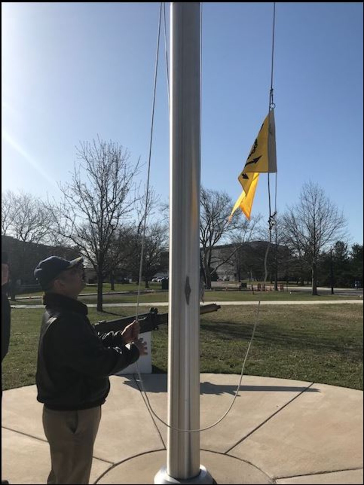 U.S. Navy Capt. Muhammad M. Khan, Joint Base McGuire-Dix-Lakehurst deputy commander and Naval Support Activity Lakehurst commander, raises a pennant to honor the unit earning the 2017 Retention Excellence Award at Joint Base MDL, NJ April 5, 2018. NSA Lakehurst had 100 percent retention rate for all first-term Sailors. (Courtesy Photo)