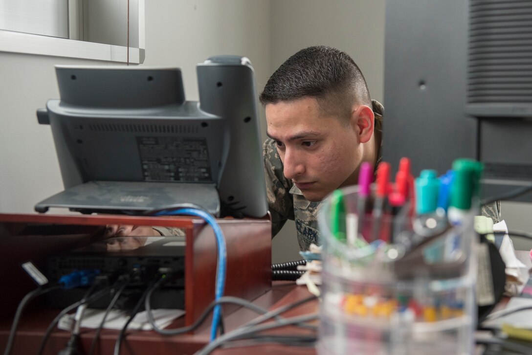 Senior Airman Shawn Clark, 374th Communications Squadron Operations Flight client systems technician journeyman, attempts to turn on a computer while troubleshooting at Yokota Air Base, Japan, April 5, 2018.