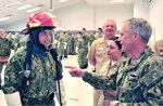 Commander, U.S. 7th Fleet Vice Adm. Phil Sawyer, receives a demonstration at the applied firefighting and damage control lab, part of the new Hands-on Learning curriculum at Recruit Training Command designed to develop recruits with critical warfighting skills during basic training.